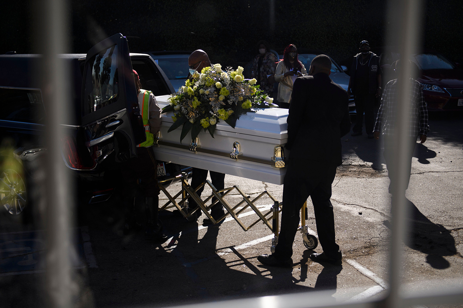 A casket is loaded into a hearse at the Boyd Funeral Home, as burials at cemeteries are delayed to the surge of Covid-19 deaths on January 14, in Los Angeles, California.