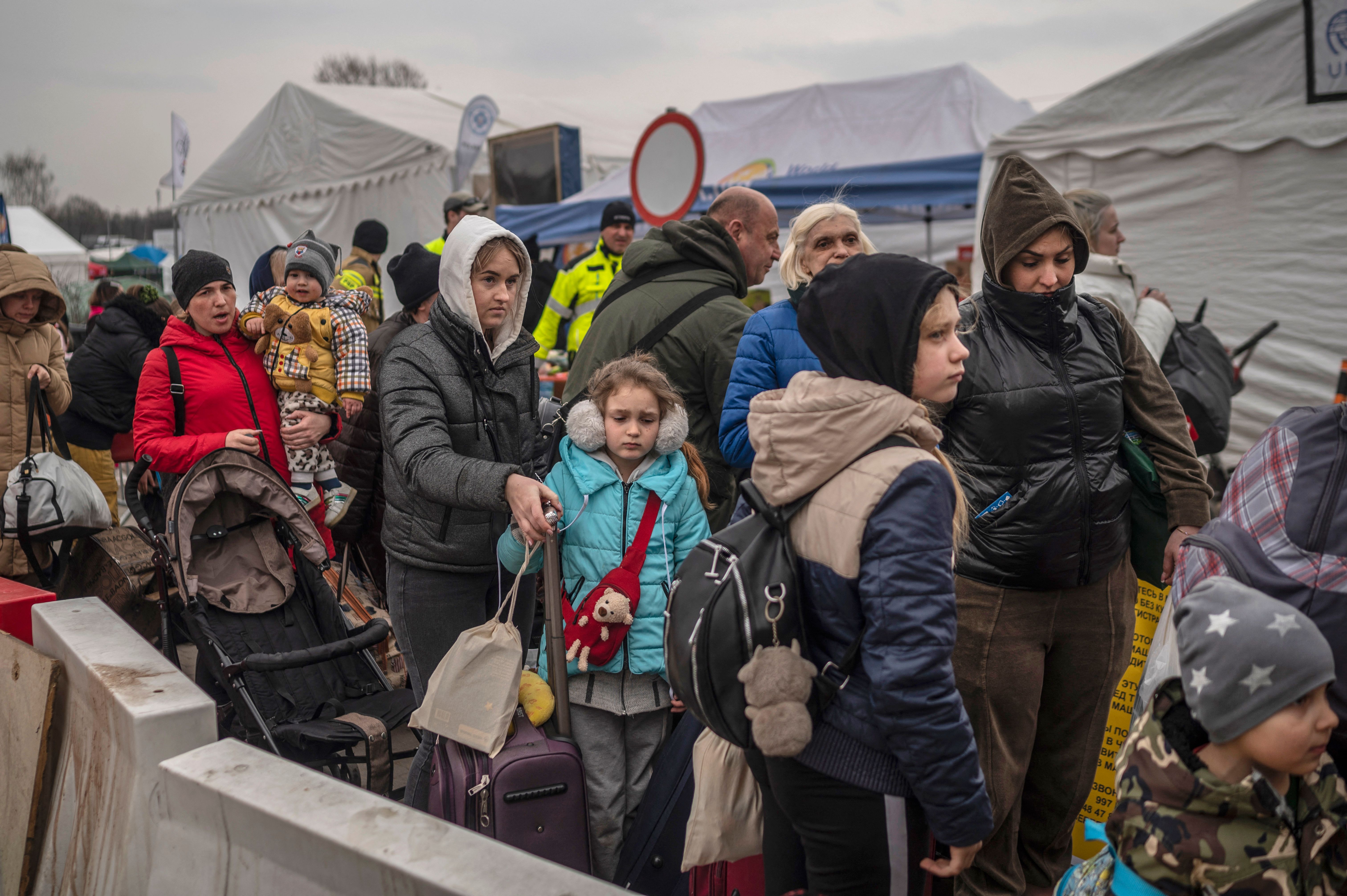 Ukrainian evacuees line up as they wait to cross the border at Medyka, Poland on March 29.