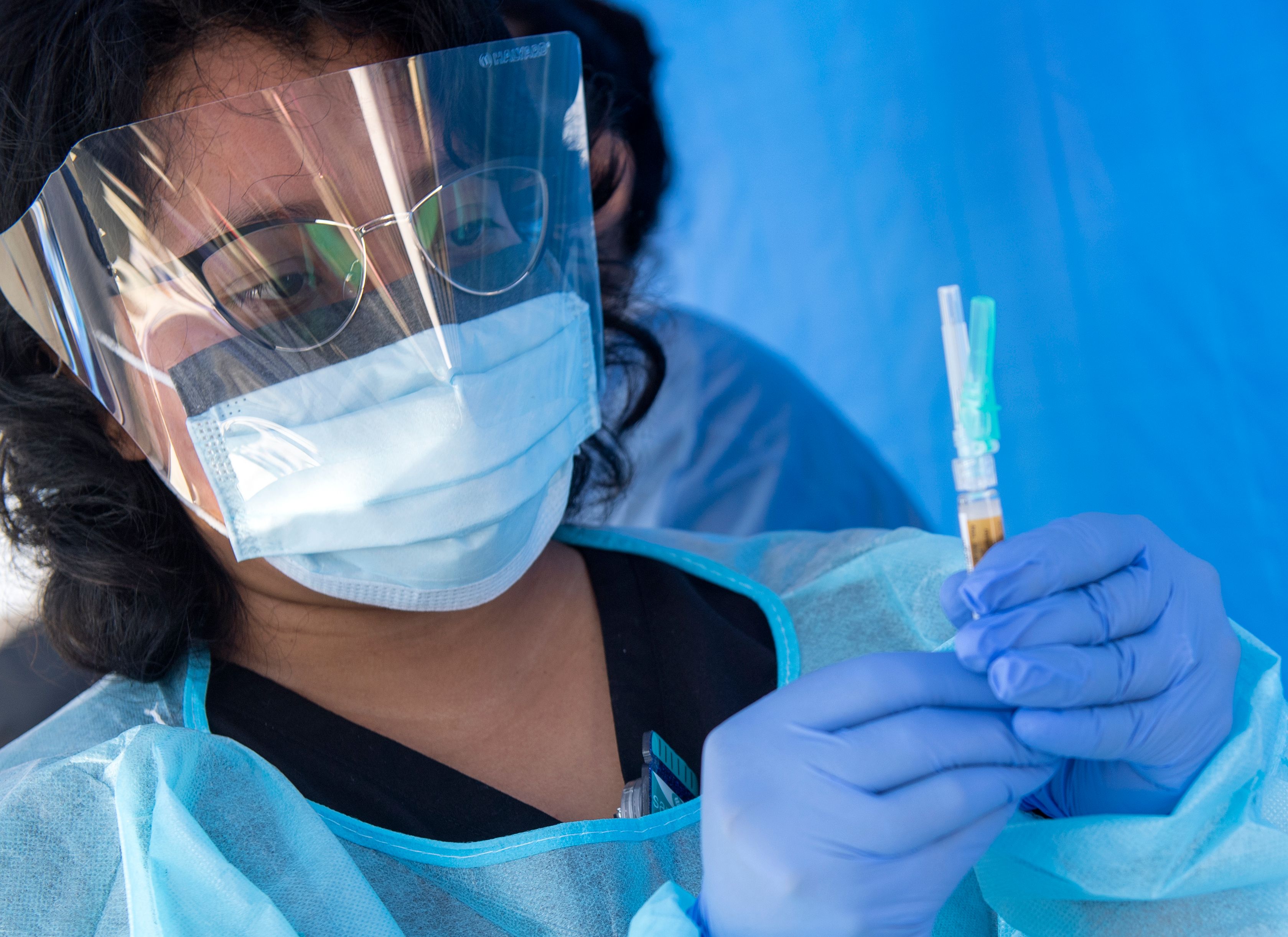 A health worker prepares a vaccine during the Saban Community Clinic Vaccine Drive Up for LA Children on August 12 in Los Angeles, California.