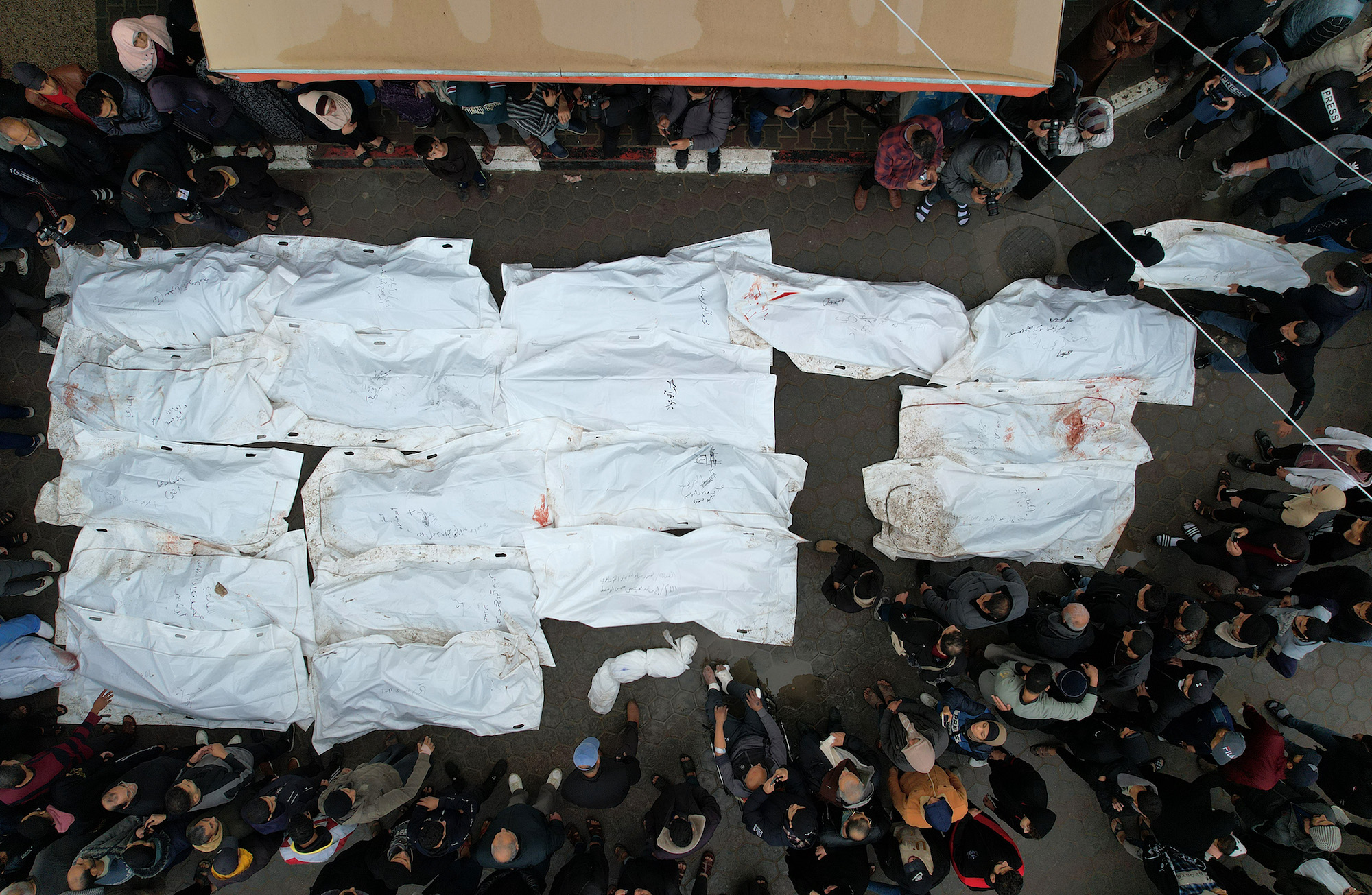 The covered bodies of Palestinians killed by Israeli airstrikes are seen at the Al-Aqsa Martyrs Hospital in Gaza on December 25.