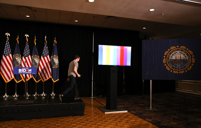 A worker sets up the stage at Joe Biden's primary night event at the Radisson Hotel on Tuesday, February 11 in Nashua, New Hampshire. Joe Biden's campaign announced earlier in the day that he would skip his New Hampshire primary night event and instead travel to South Carolina to begin campaigning in the state ahead of their primary on February 29th. 