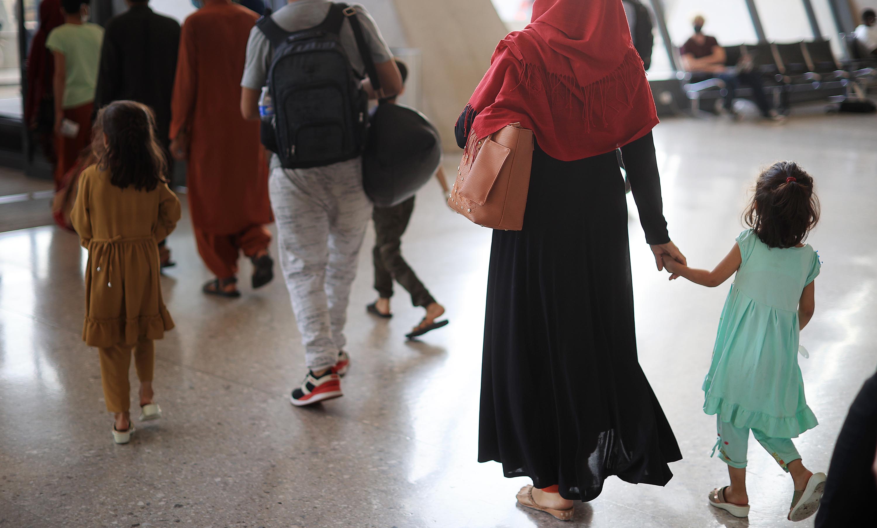 Refugees arrive at Dulles International Airport after being evacuated from Kabul, August 27, in Dulles, Virginia. 