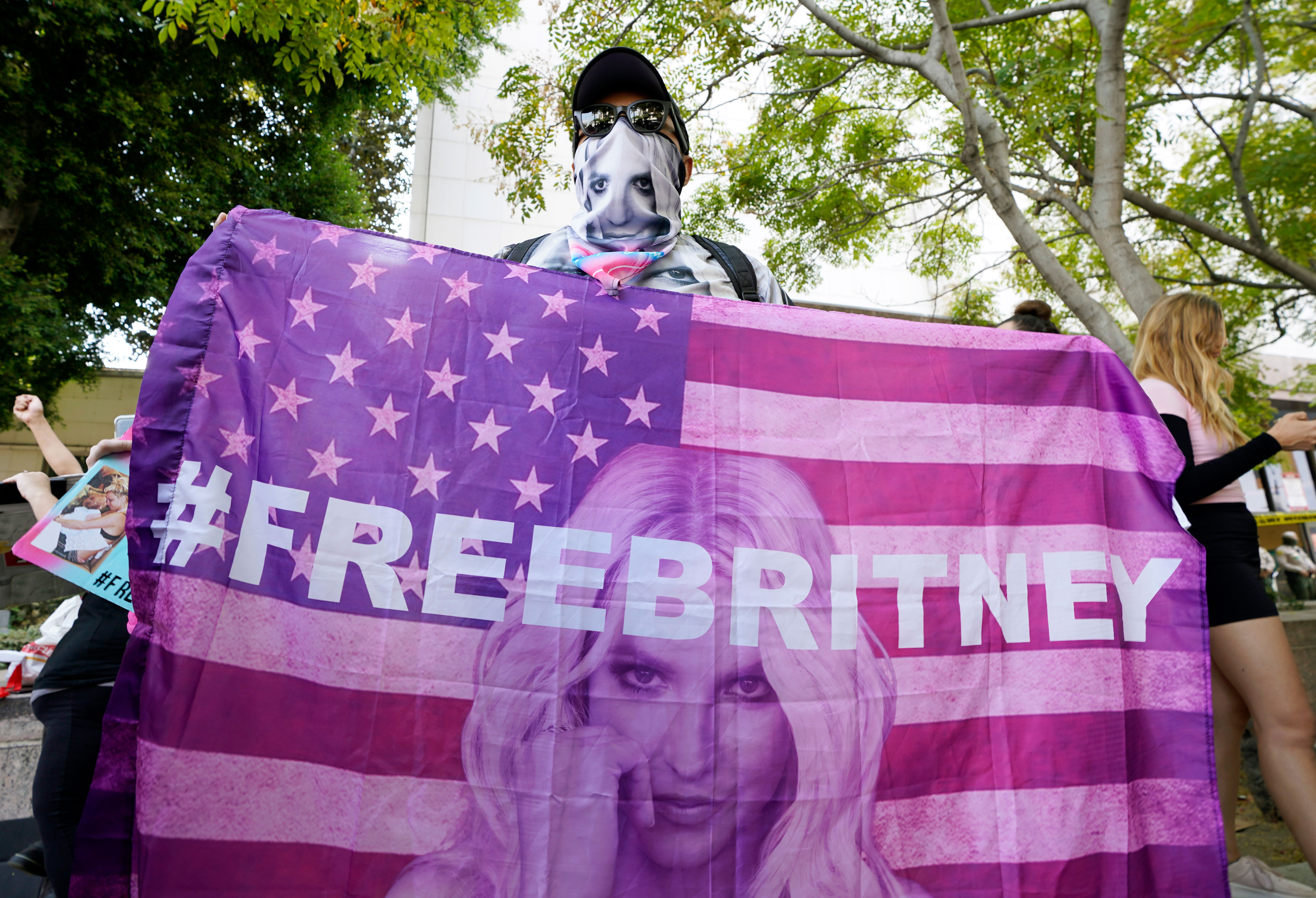 A person holds an American flag with an image of Britney Spears and the hashtag "FreeBritney" outside the Stanley Mosk Courthouse in Los Angeles on September 29.