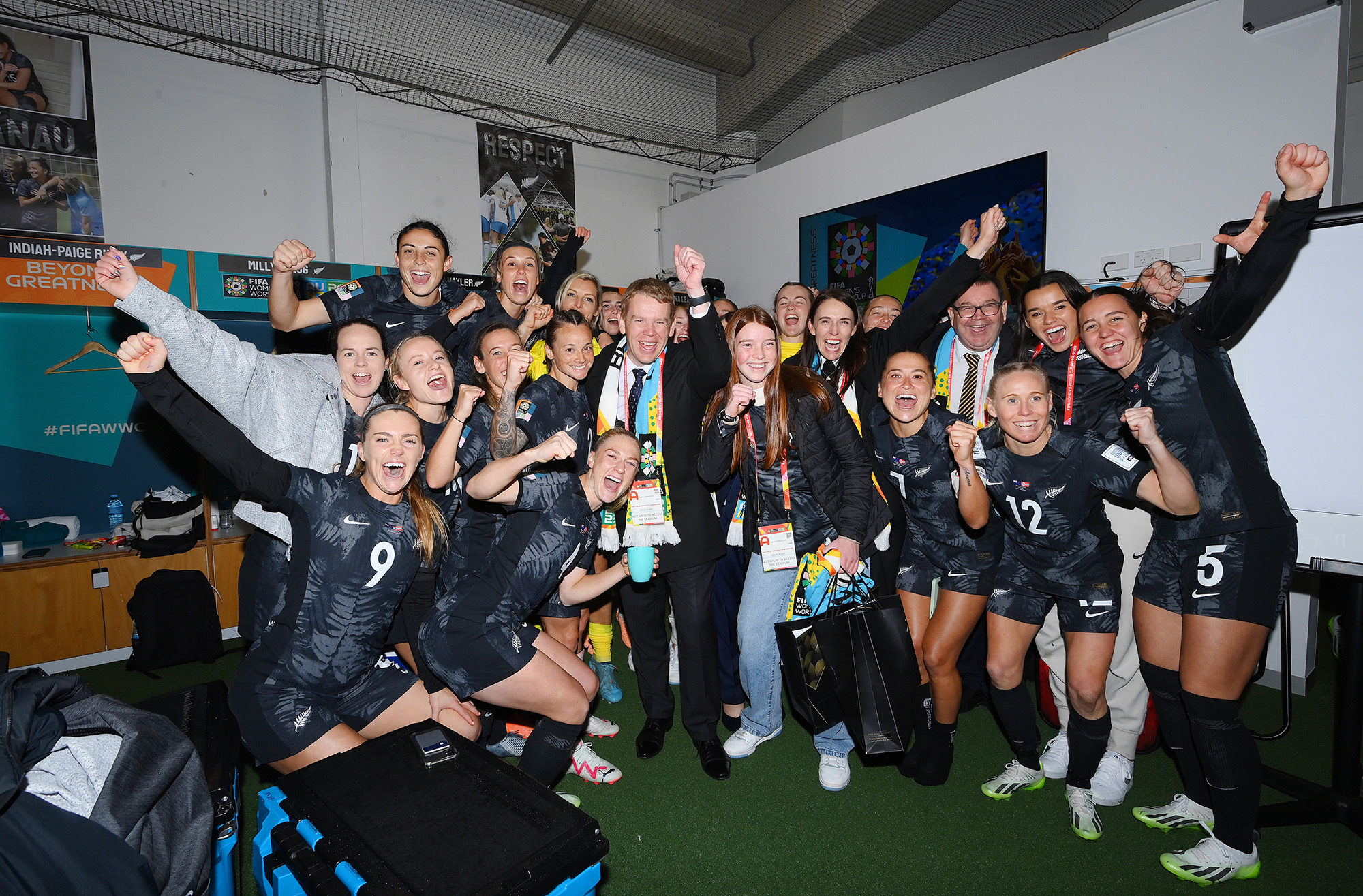 Chris Hipkins, center, Prime Minister of New Zealand, and New Zealand players celebrate the team's 1-0 victory in the dressing room at Eden Park on July 20, in Auckland.
