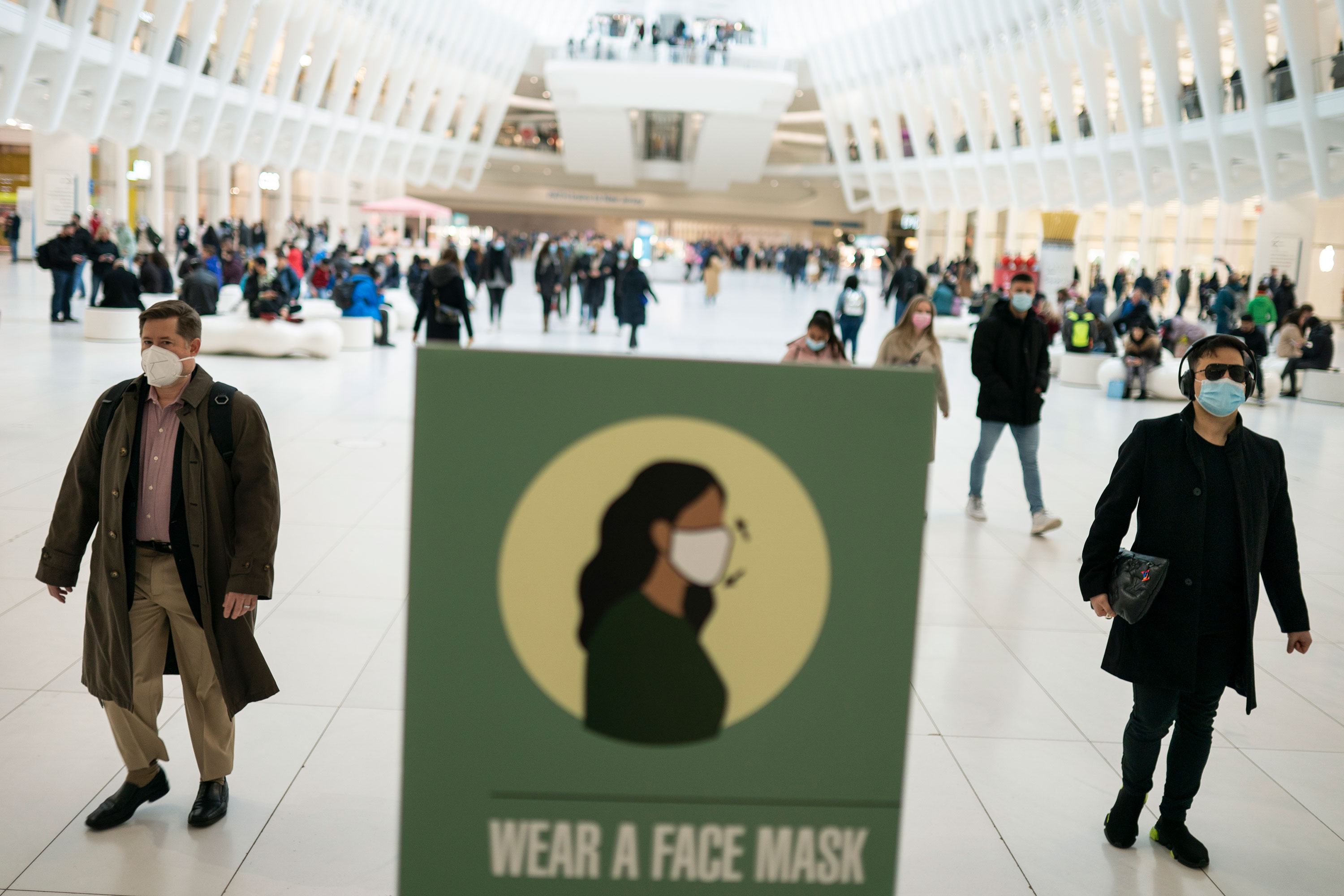 Mass transit riders wear masks as they commute thru the Oculus in Manhattan on Tuesday.