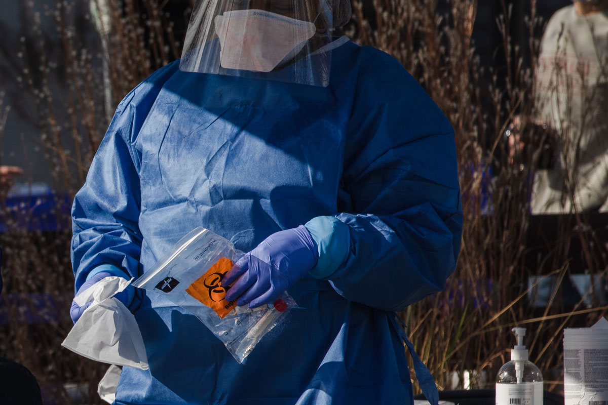 A healthcare worker from the Medical University of South Carolina holds a bio-hazard bag at a Covid-19 test site in Charleston, South Carolina on January 13.