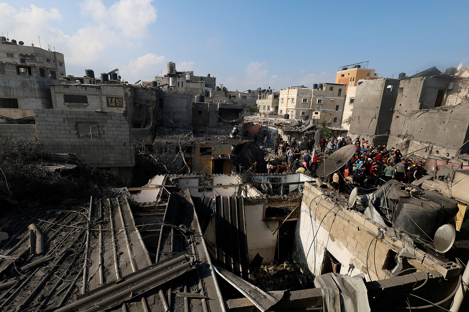 Palestinians inspect damage from Israeli strikes in Khan Younis, Gaza, on December 1.