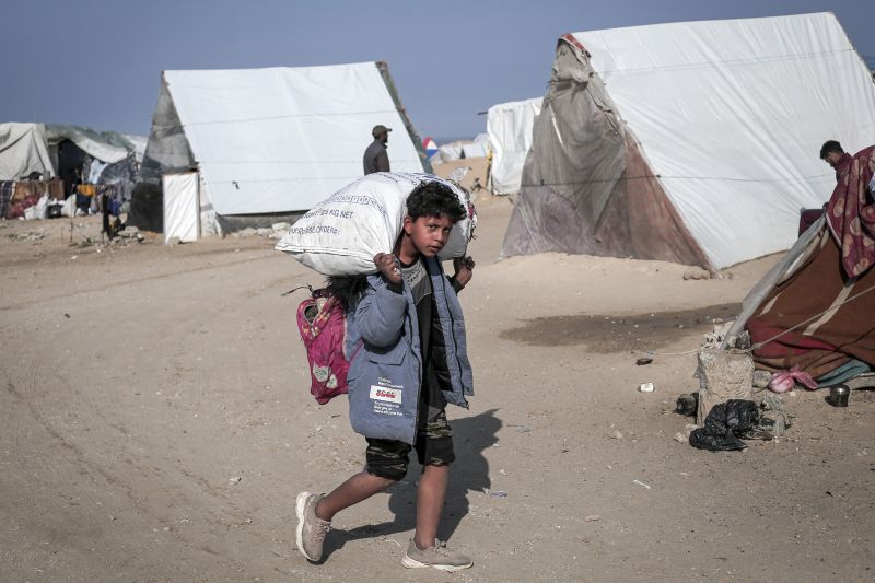 A child carries a sack filled with personal belongings at a camp for displaced Palestinians in Rafah, Gaza, on February 28.