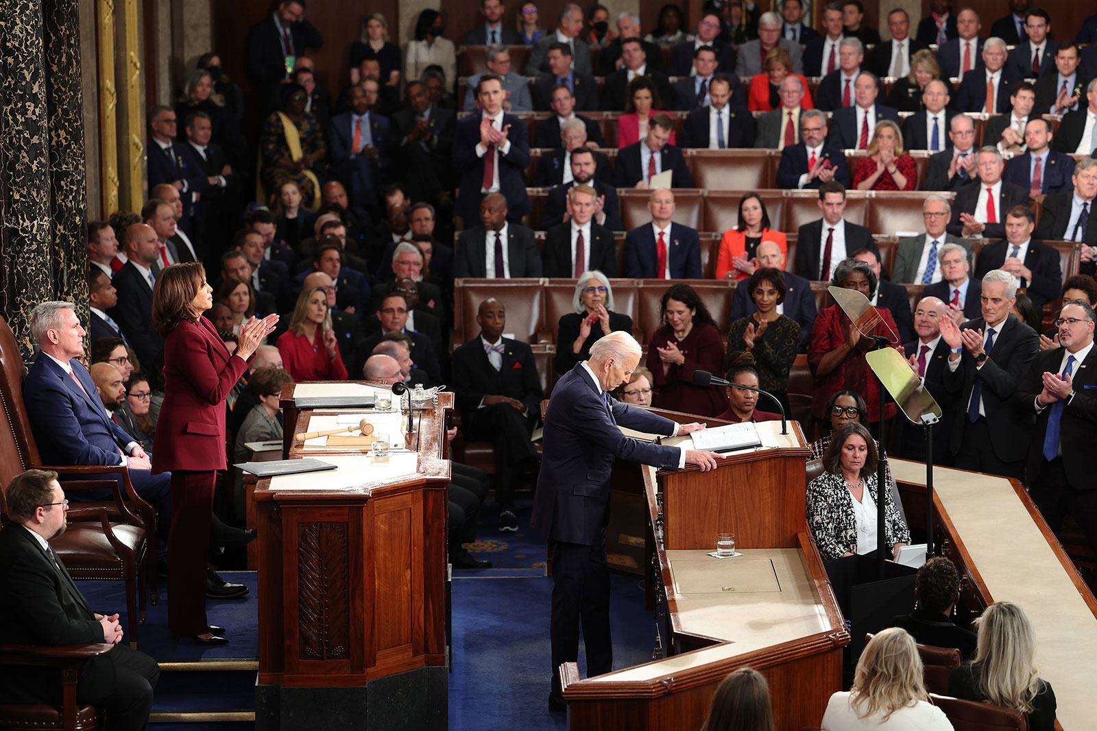 House Speaker Kevin McCarthy and many Republican lawmakers sit as others stand to applaud during Biden's address.