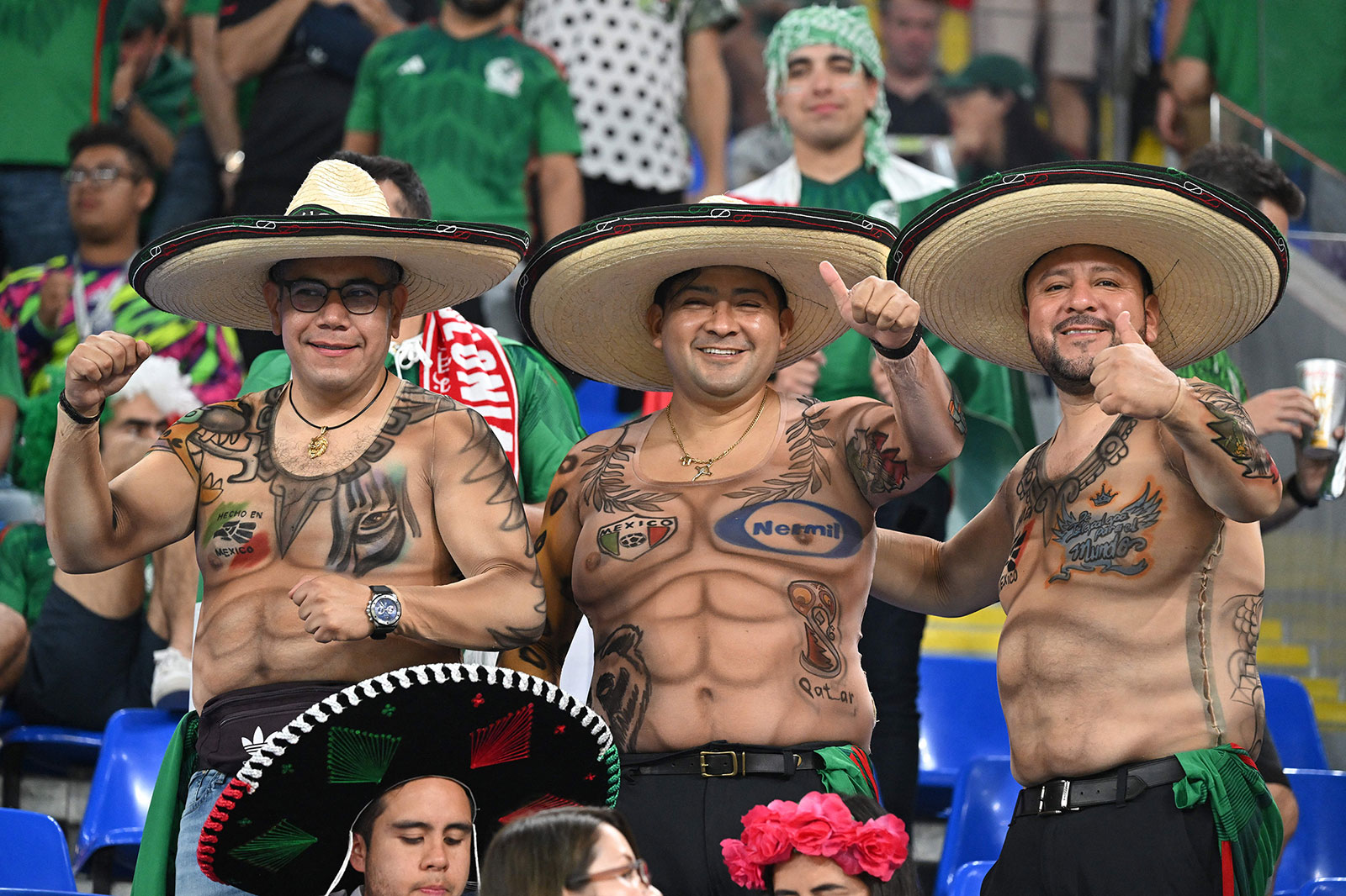 Mexico supporters, wearing tattoo-inspired shirts, cheer ahead of the match between Mexico and Poland on November 22. 