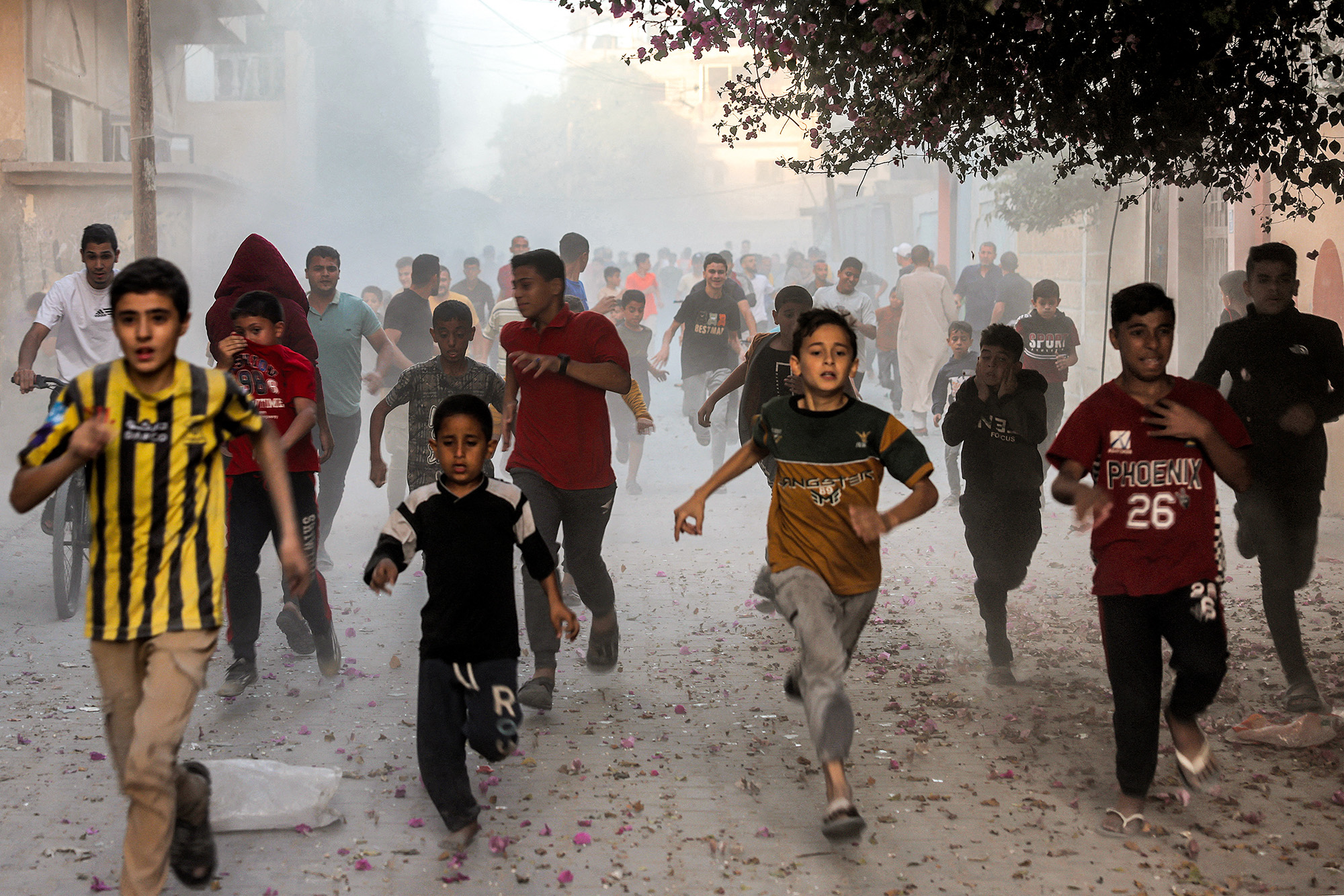 Palestinian children run as they flee from Israeli bombardment in Rafah, Gaza, on November 6.