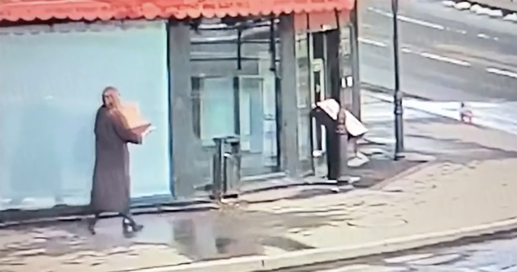 Footage allegedly showing Daria Trepova carrying a bulky box outside the cafe in St Petersburg, Russia, on April 2