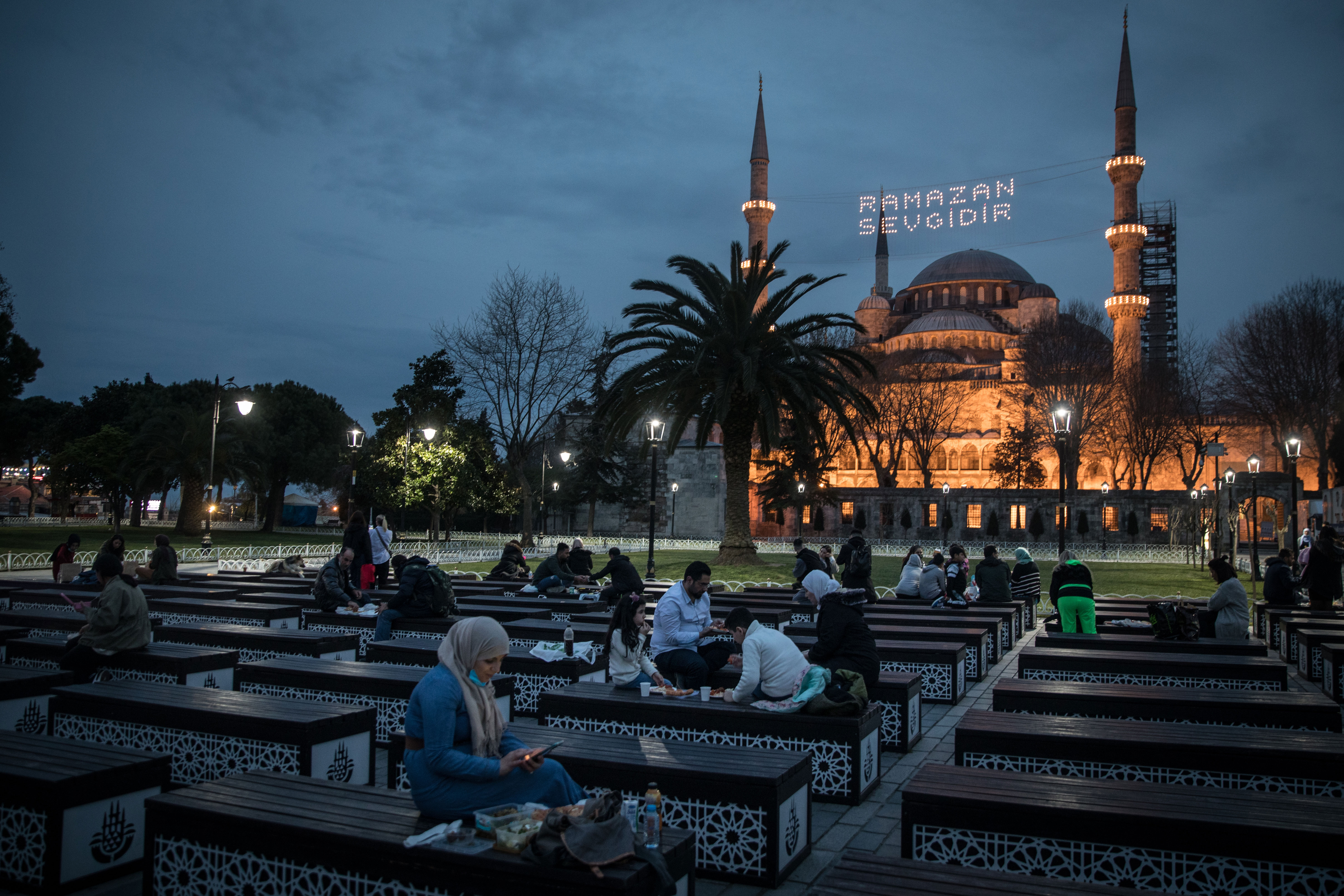 People break their fast during Ramadan in front of the Blue Mosque in Istanbul on April 13.