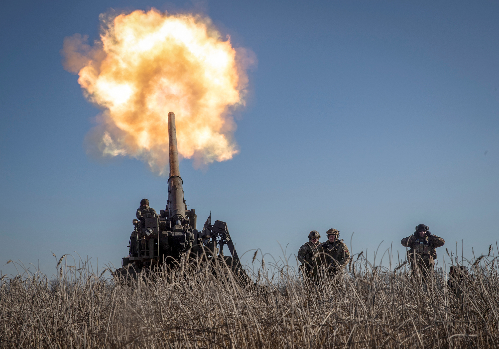 Ukrainian servicemen fire a 2S7 Pion self-propelled gun toward Russian positions on a frontline near Bakhmut in Donetsk region, Ukraine, on January 24.
