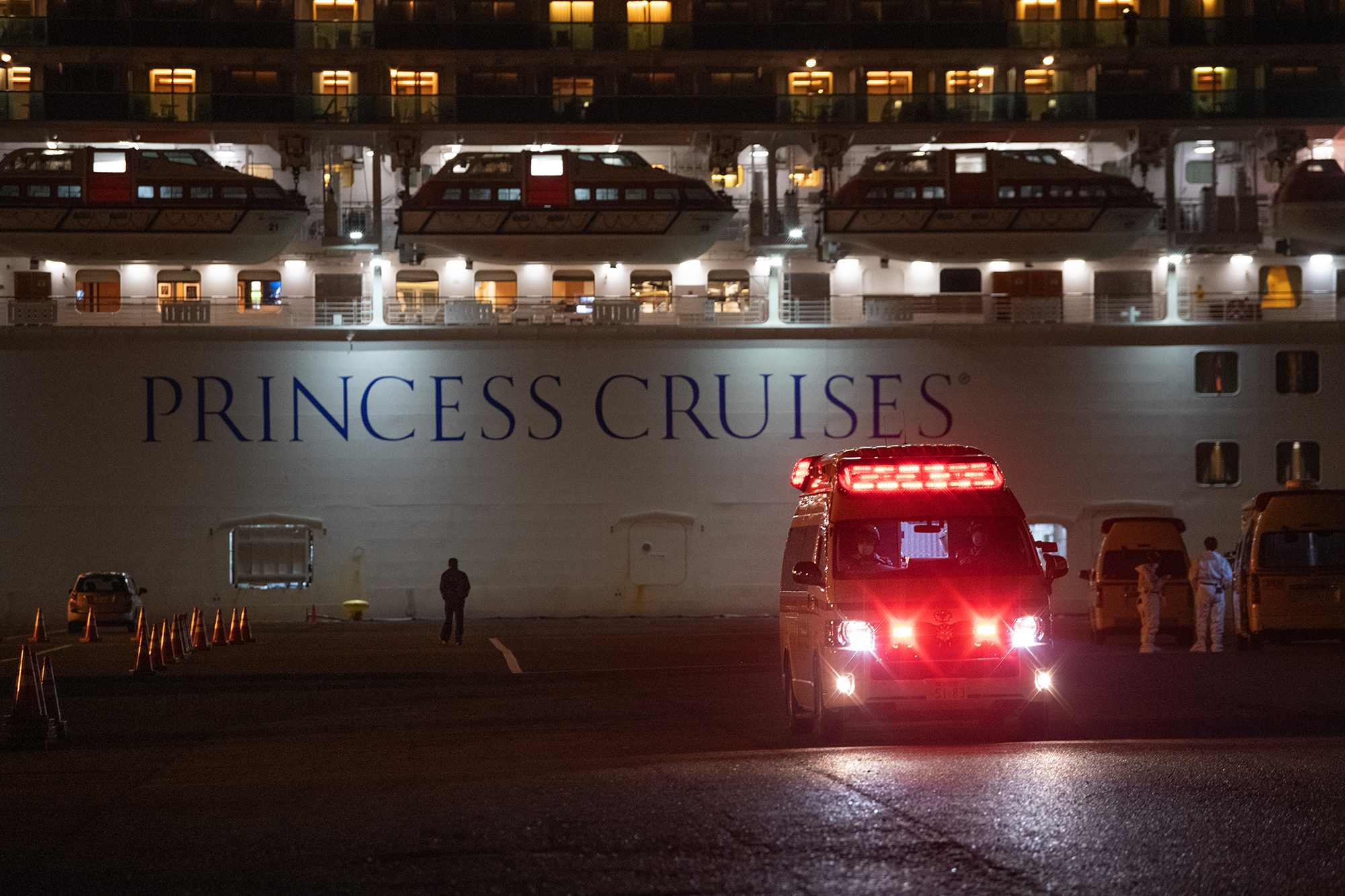 An ambulance carries a passenger diagnosed with coronavirus from the Diamond Princess at Daikoku Pier on February 10 in Yokohama, Japan. 