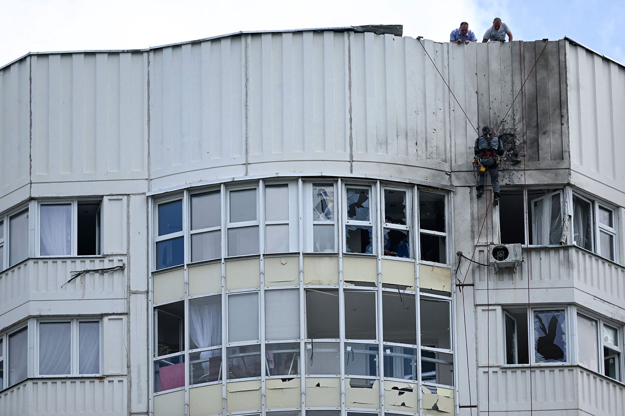 A specialist inspects the damaged facade of a multi-storey apartment building after a reported drone attack in Moscow, Russia, on May 30.