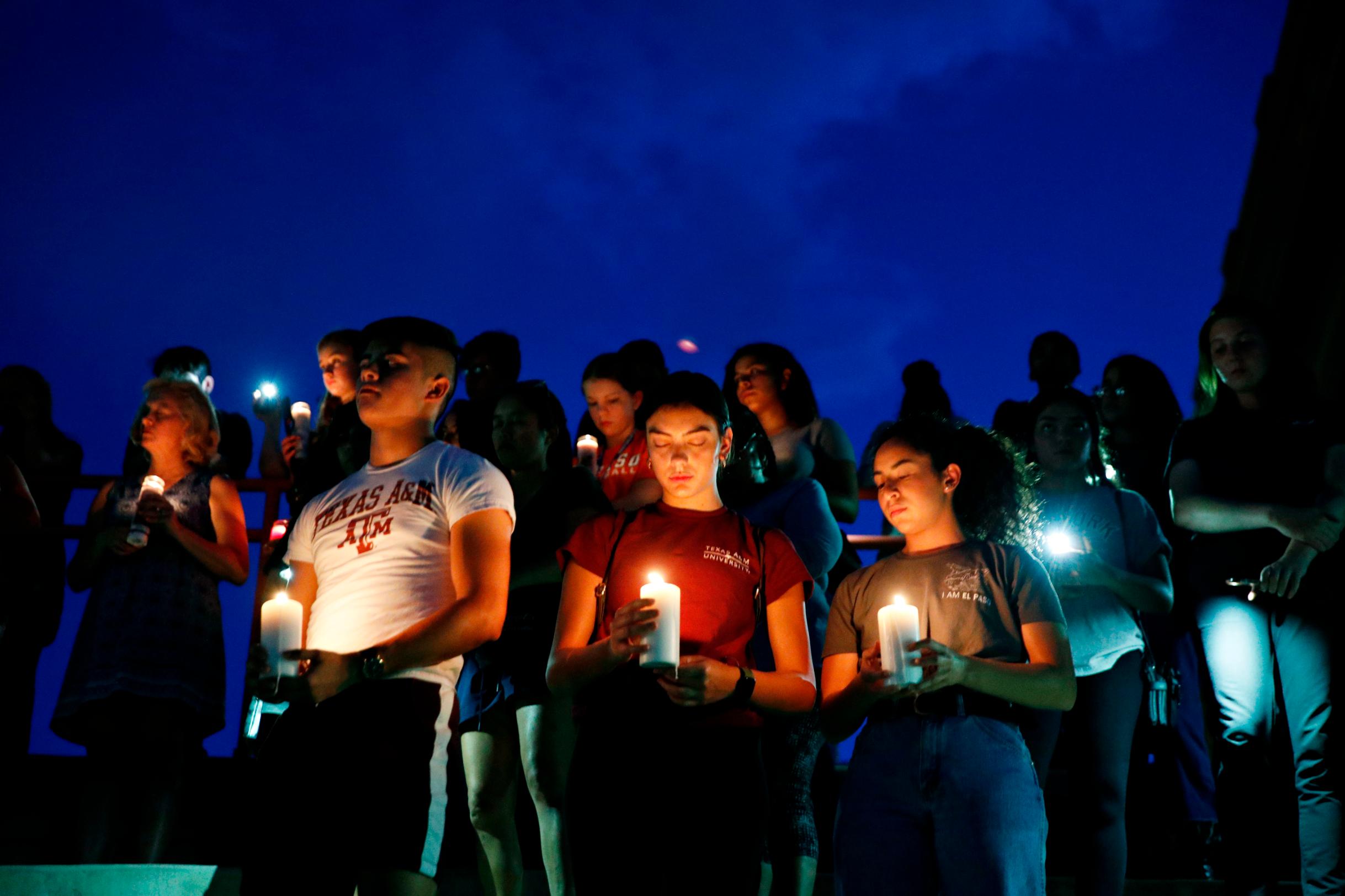 From left, Samuel Lerma, Arzetta Hodges and Desiree Quintanar attend a vigil for victims of the deadly shooting in El Paso on Saturday. 