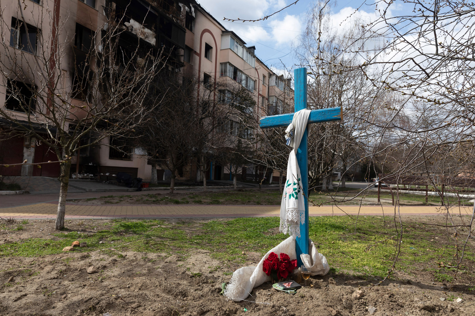 A wooden cross stands near the site of a mass grave in Bucha, Ukraine, on Tuesday.
