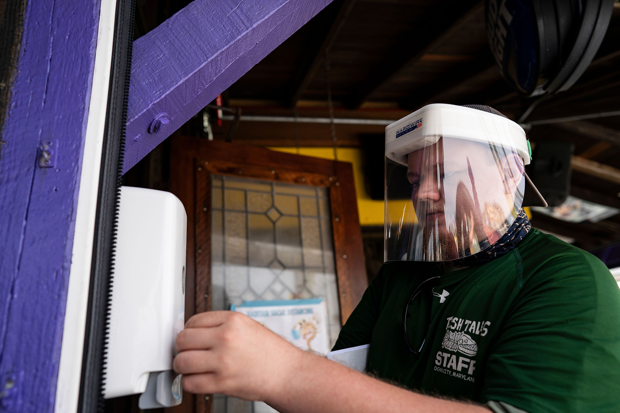 A restaurant employee with a hand sanitizer dispenser in Ocean City, Maryland, on May 29. 