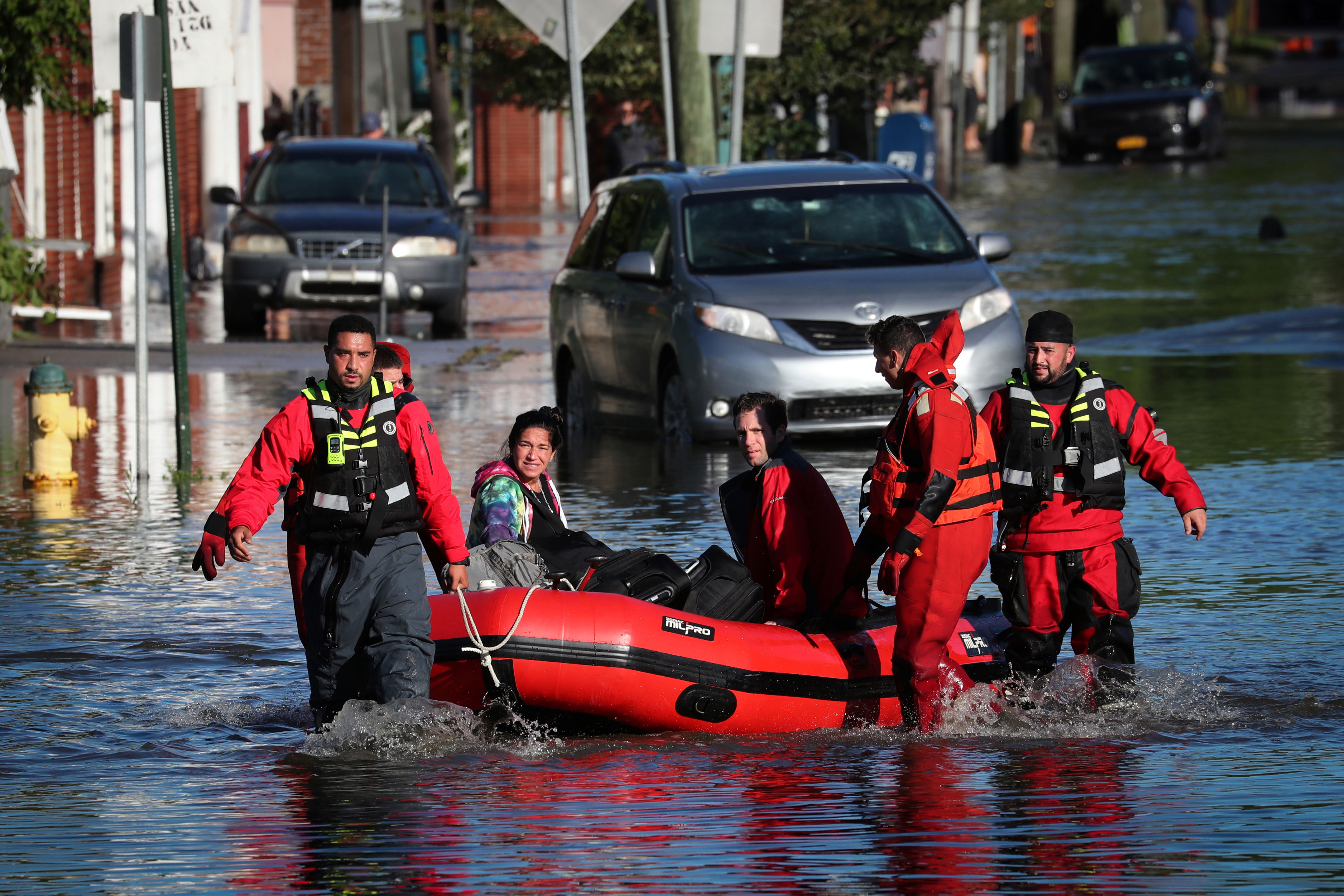 First responders pull residents in a boat as they rescue people trapped by floodwaters in Mamaroneck, New York, on September 2.