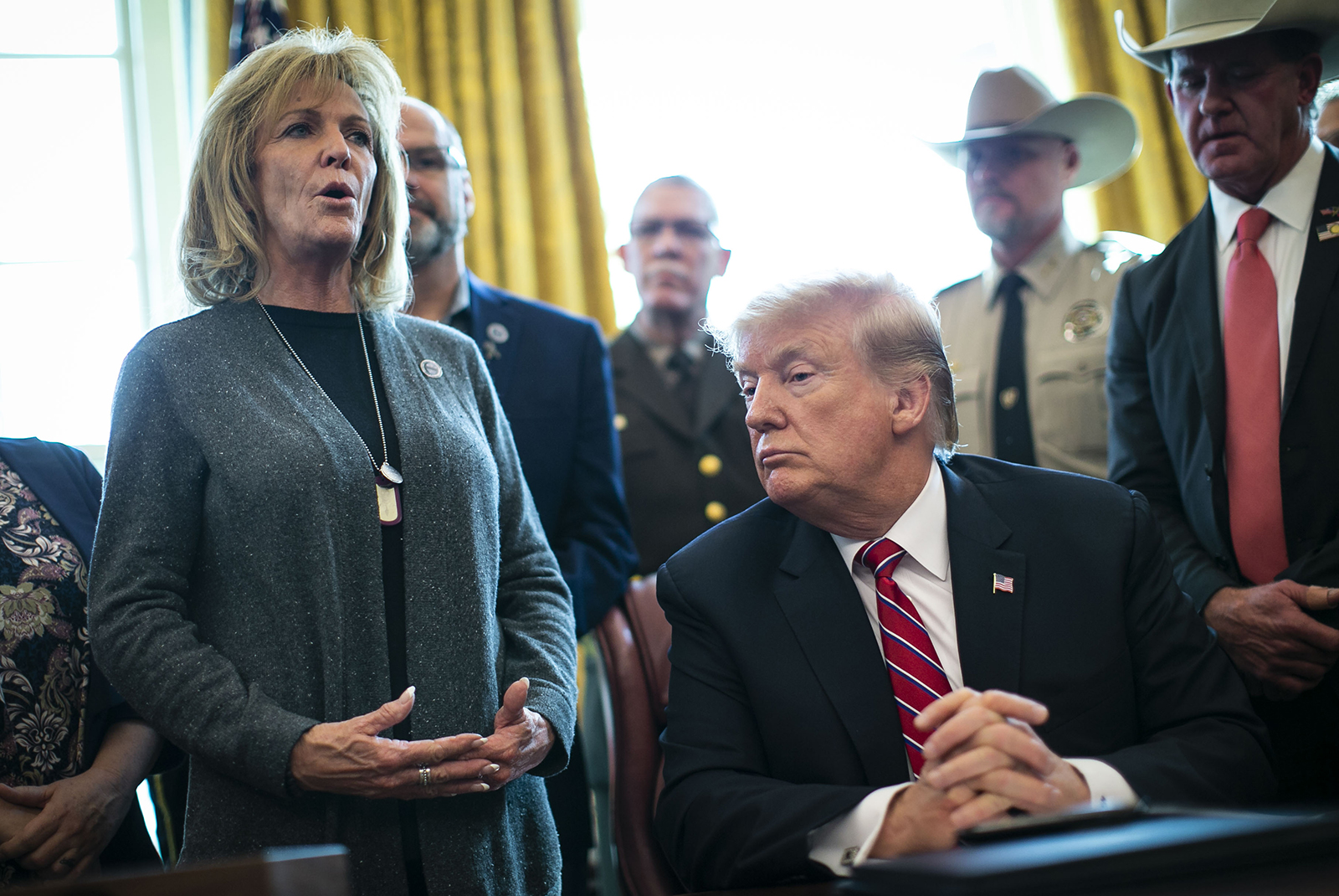 In this March 15, 2019 file photo, Immigration Reform Advocate Mary Ann Mendoza speaks as President Donald Trump listens during a veto signing in the Oval Office of the White House in Washington.