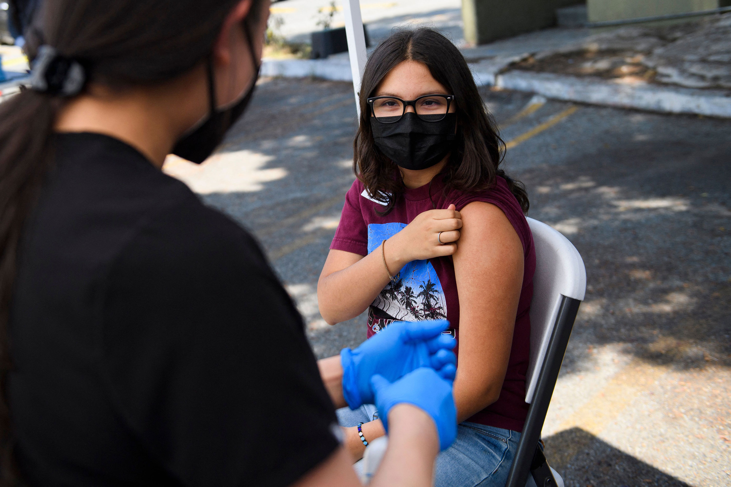 A 16-year-old rolls up their sleeve to receive a first dose of the Pfizer Covid-19 vaccine at a mobile vaccination clinic in Los Angeles in May.