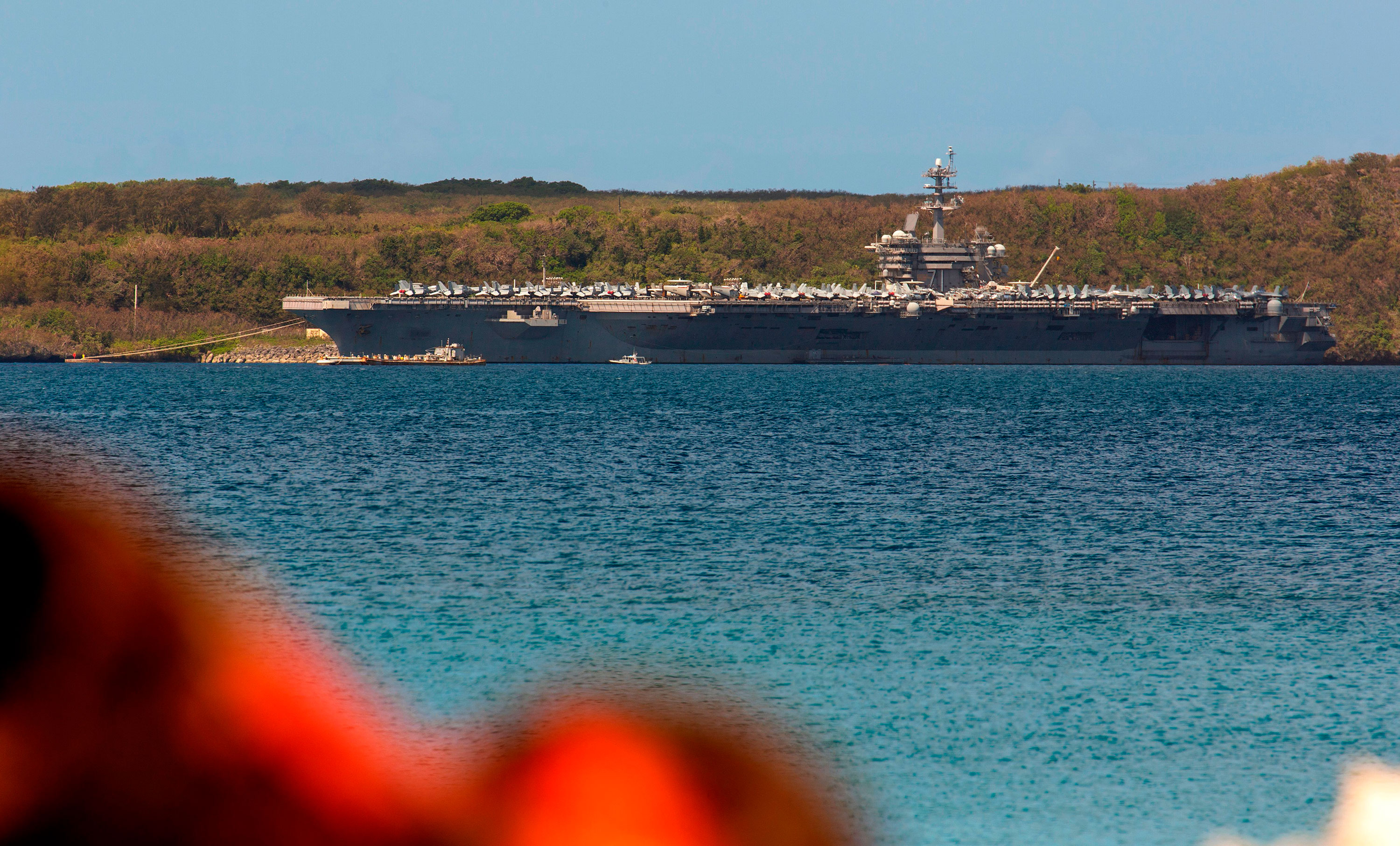 The aircraft carrier USS Theodore Roosevelt is seen docked at Naval Base Guam in Apra Harbor on April 10.