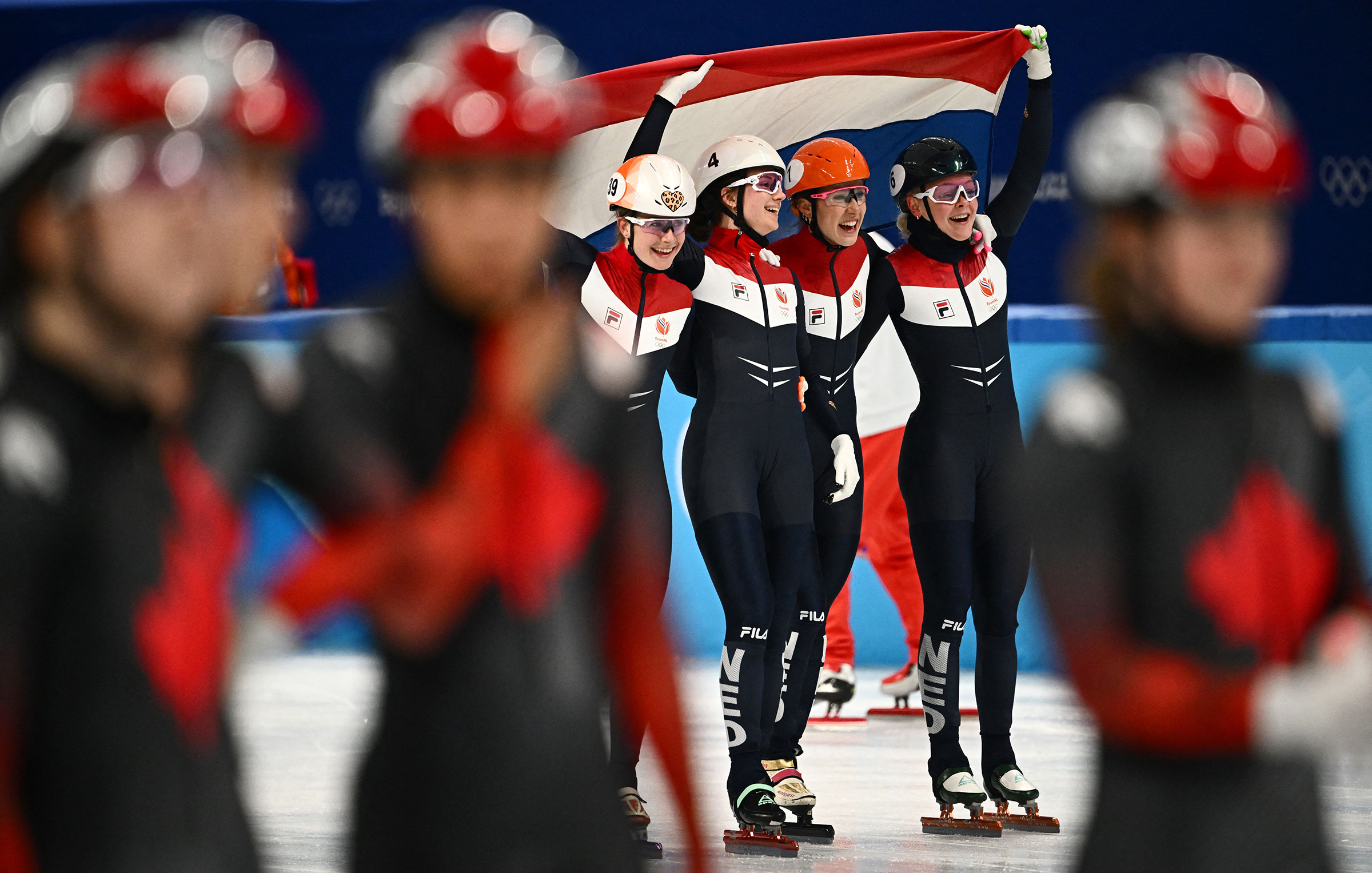 The Netherlands' team celebrates winning the women's 3,000m relay short track speed skating relay on February 13. 