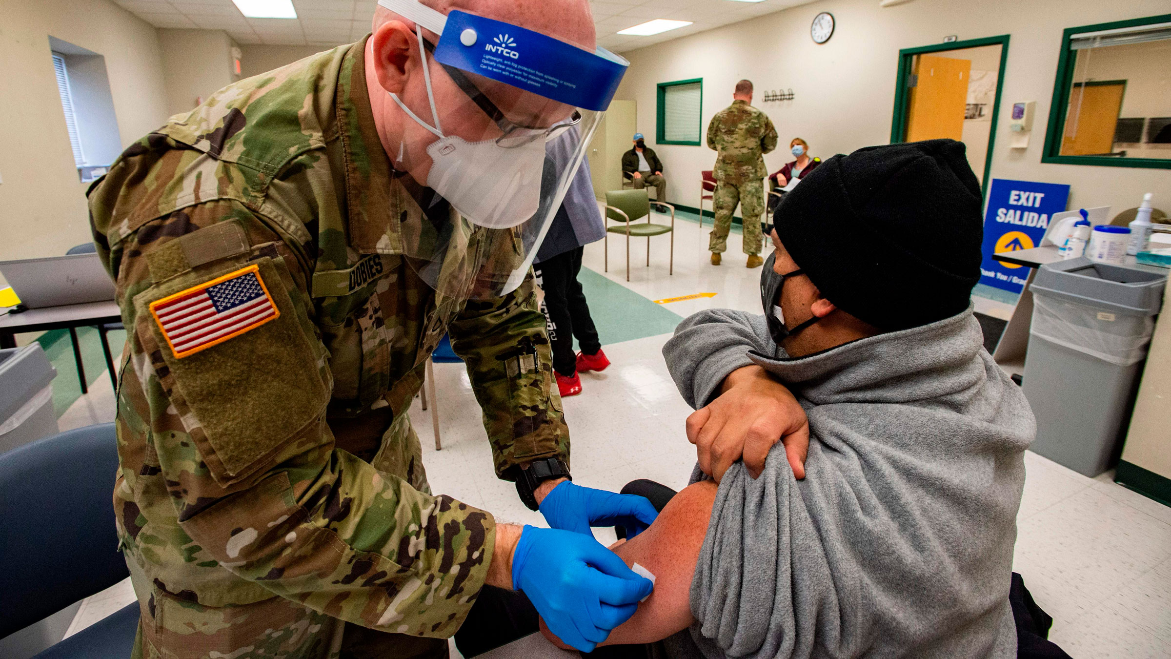A National Guardsman prepares to vaccinate a man in Boston on Tuesday.