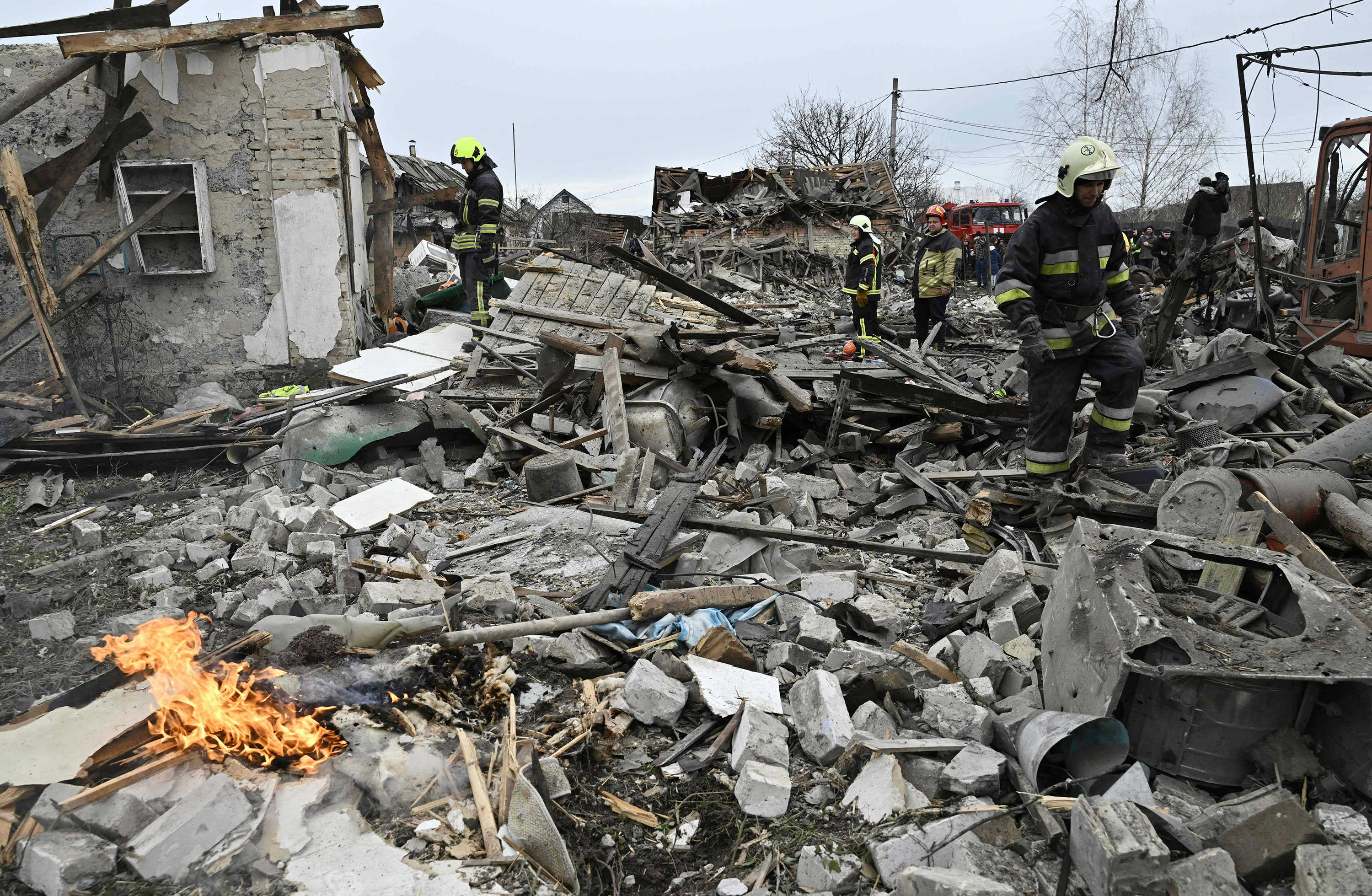 Rescuers clear debris of homes destroyed by a missile attack in the outskirts of Kyiv, on Thursday, December 29, following a Russian missile strike. Russian missile strikes battered Ukraine including in major cities like Kyiv, Kharkiv and Lviv on Thursday. 