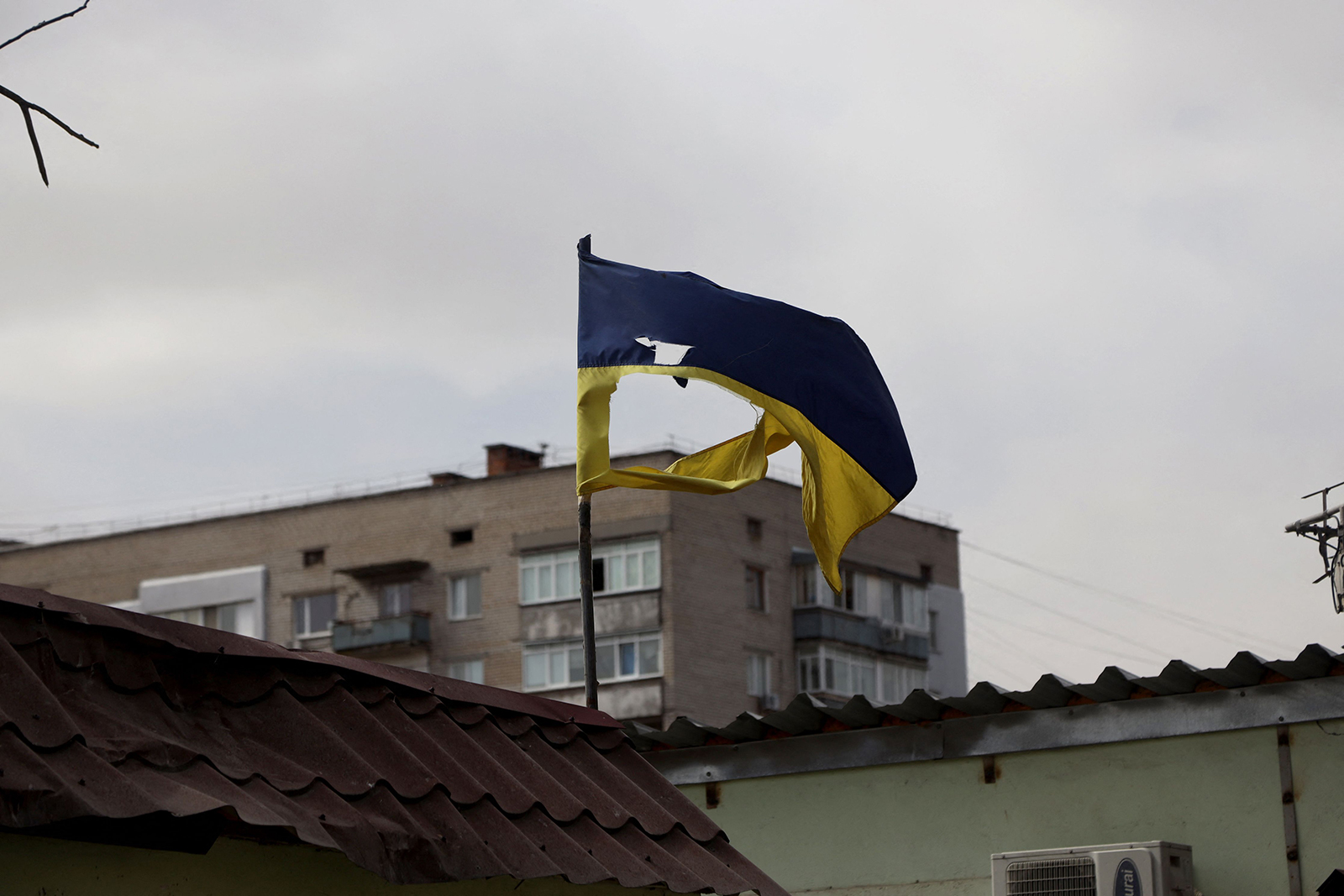 A Ukrainian flag torn by fragments after Russian shelling flutter in Mykolaiv, a key city on the road to Odessa, Ukraine's biggest port on March 27.