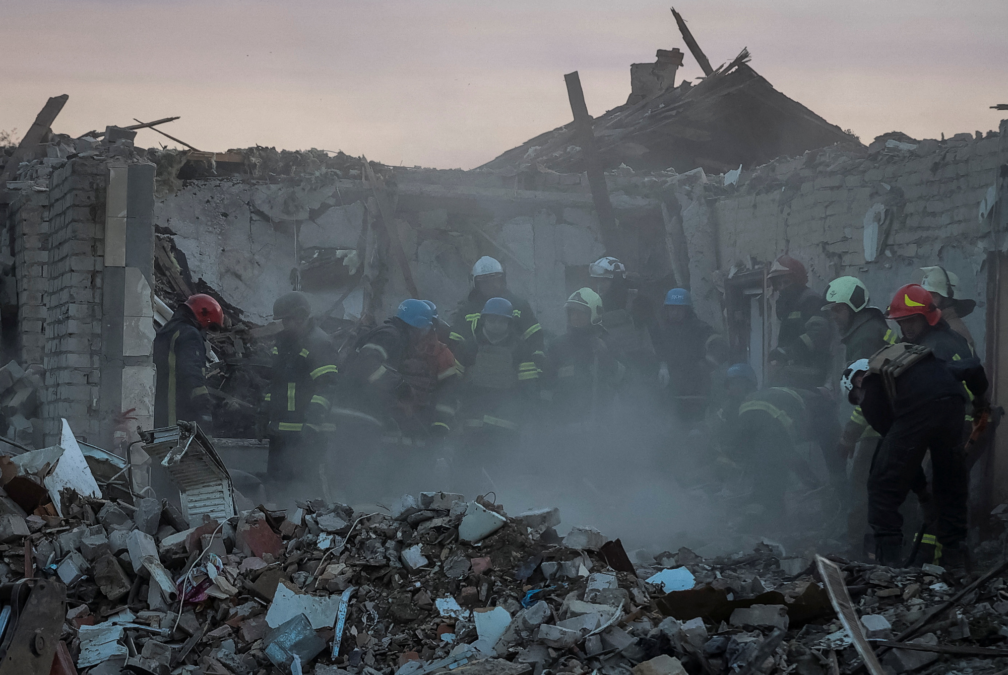 Rescues work at a site of a Russian military strike in Kupiansk on Thursday.