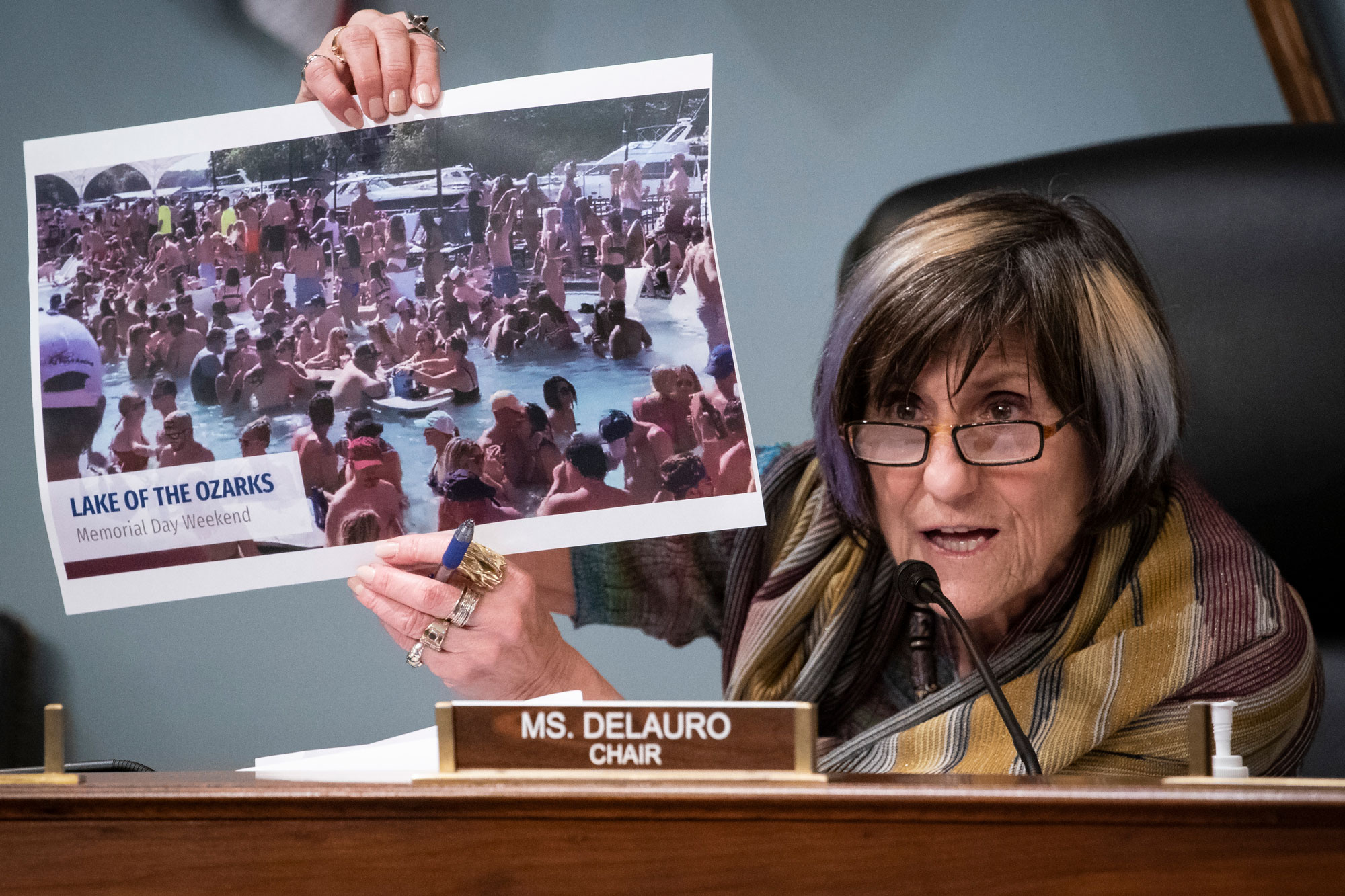 Representative Rosa DeLauro, a Democrat from Connecticut and chairwoman of the House Appropriations Subcommittee on Labor, Health and Human Services, Education, and Related Agencies, holds a photograph from the Lake of the Ozarks in Missouri on Memorial Day Weekend, during a hearing on Capitol Hill in Washington, D.C., U.S., on June 4.