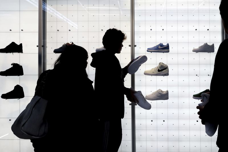 People shop for shoes in a Nike store on Black Friday, on Nov. 25, in New York.