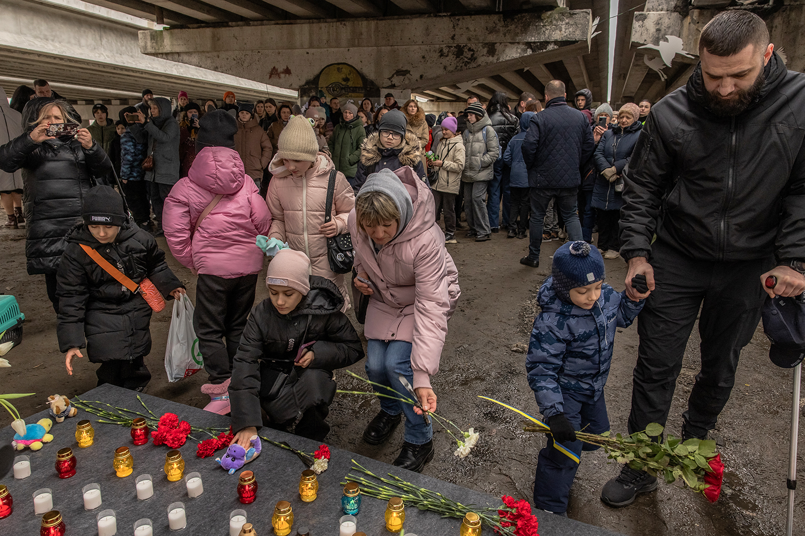 Residents attend a memorial in Irpin, Ukraine, on February 24.