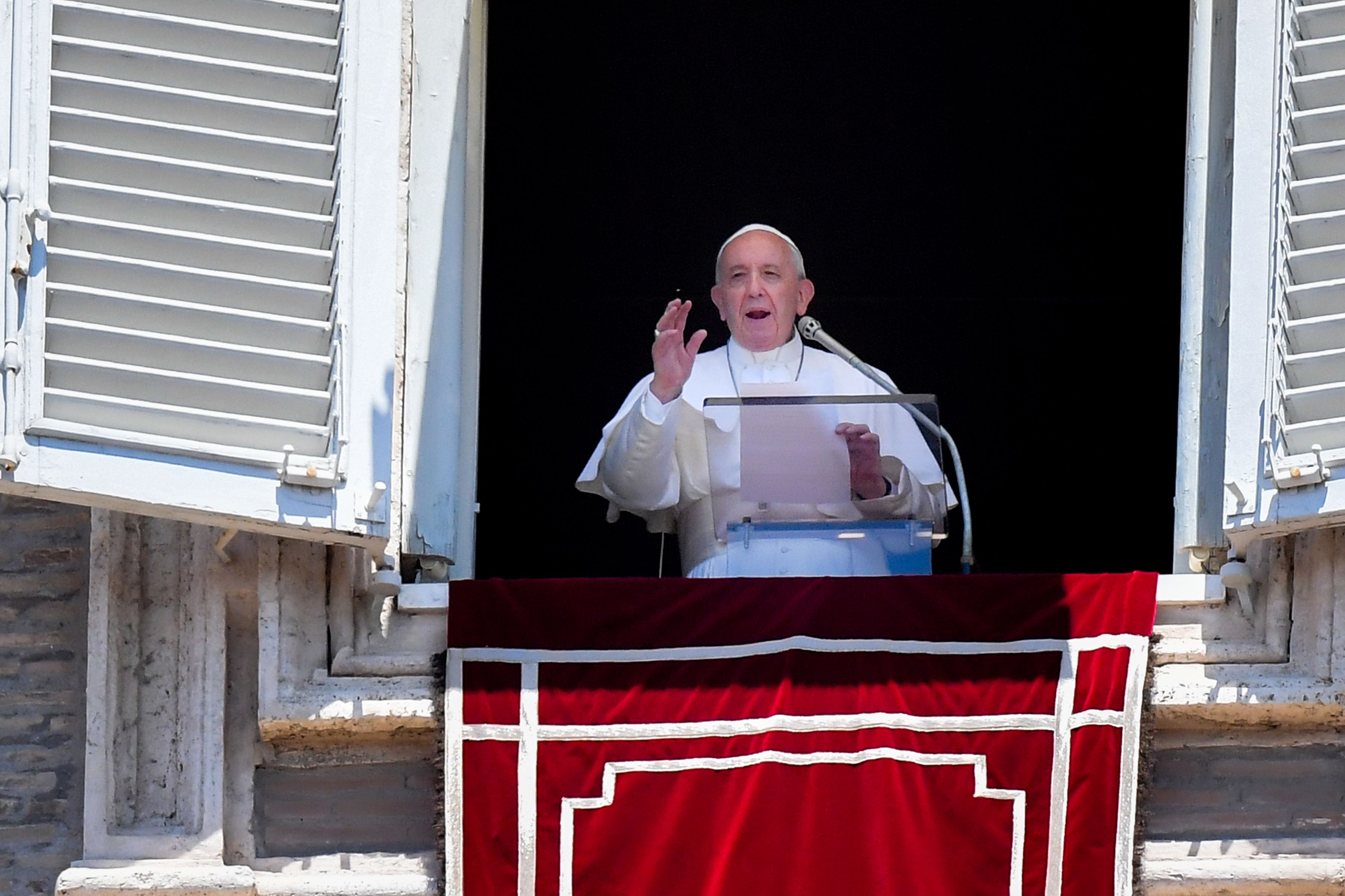 Pope Francis addresses worshipers Sunday from the window of the Apostolic Palace overlooking St. Peter's Square.