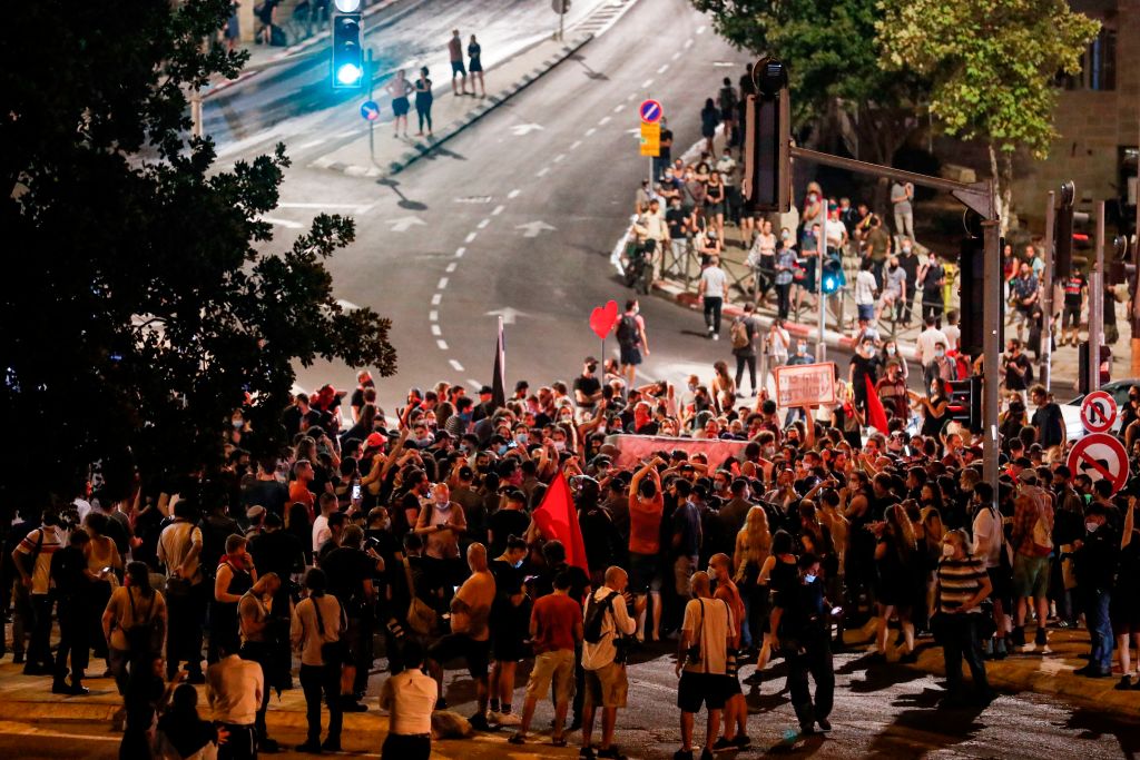 Protesters chant slogans as they march during an anti-government demonstration in Jerusalem, on July 18, 2020.