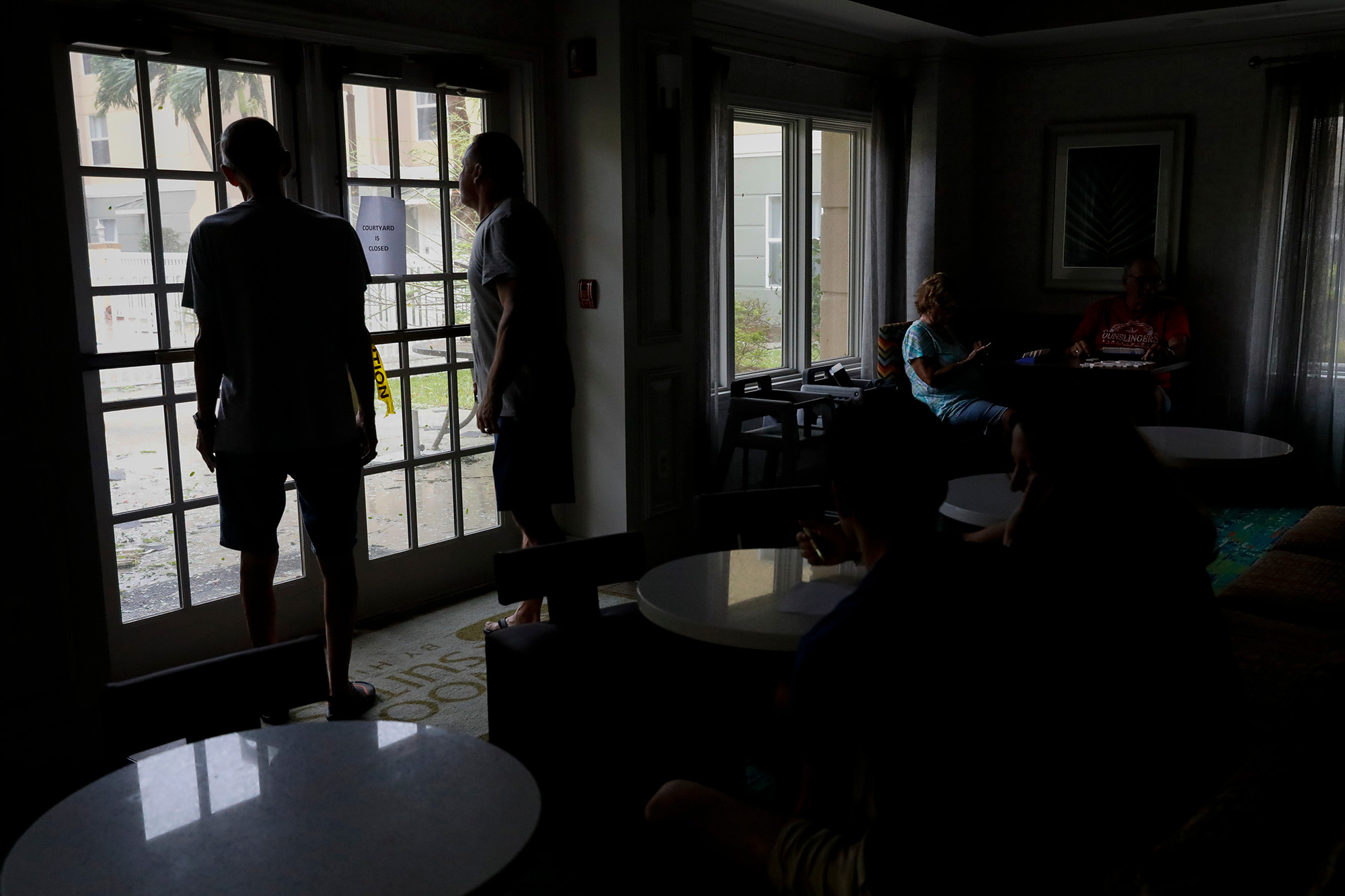 Guests look out of hotel windows as Hurricane Ian has made landfall in Fort Myers, Florida, US, on Wednesday, Sept. 28.