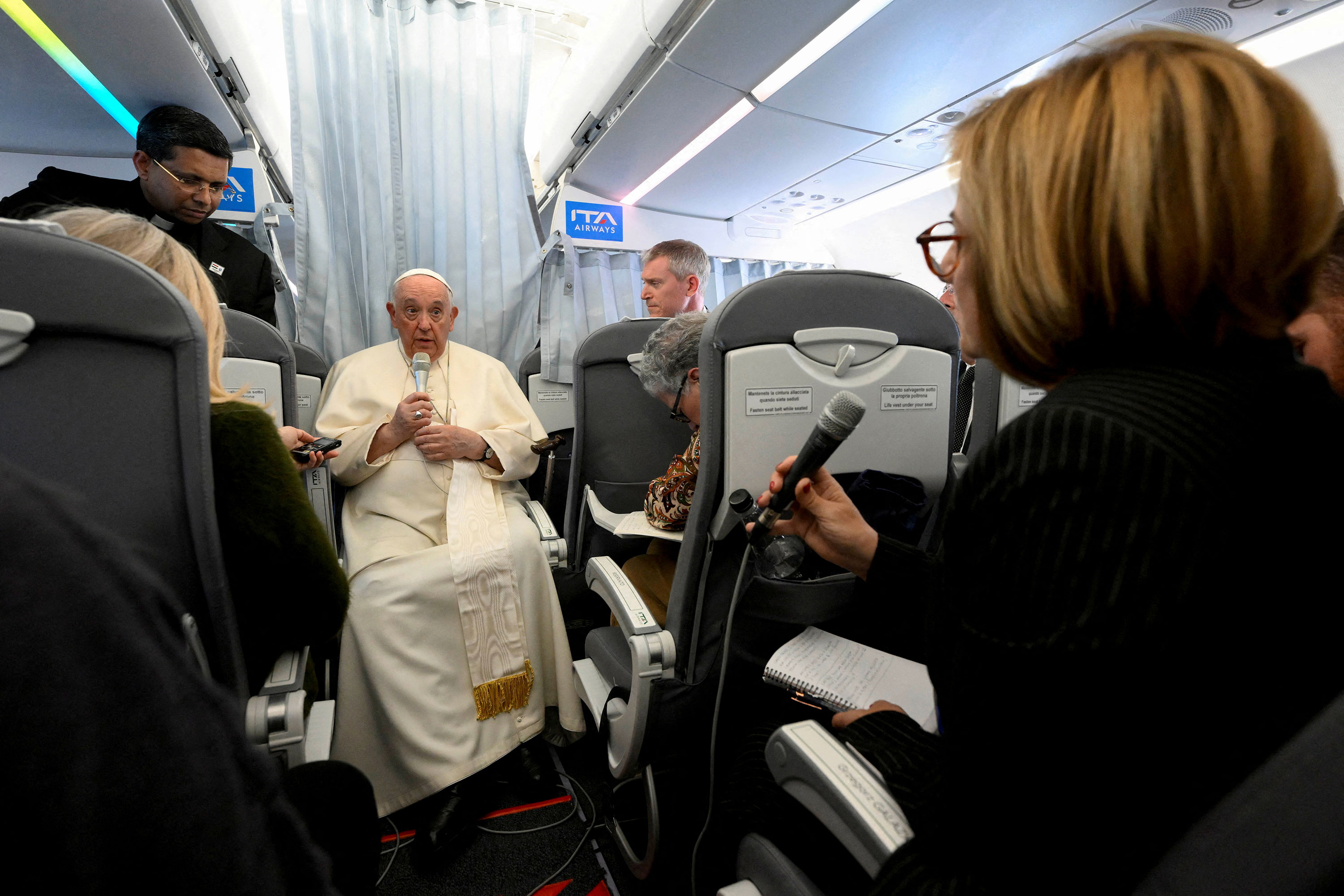 Pope Francis holds a news conference aboard a plane heading back to the Vatican from Hungary on Sunday.
