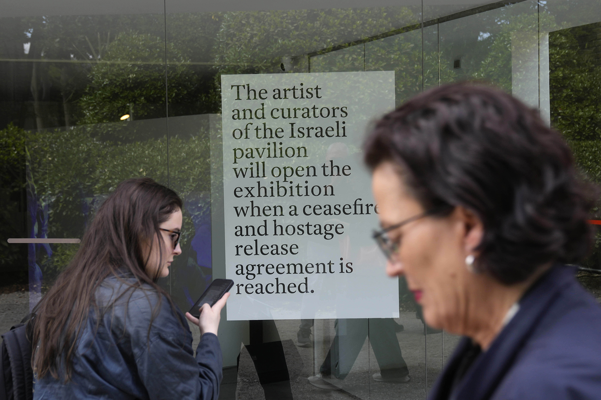 People stand in front of the closed Israeli national pavilion at the Biennale contemporary art fair in Venice, Italy, on April 16.