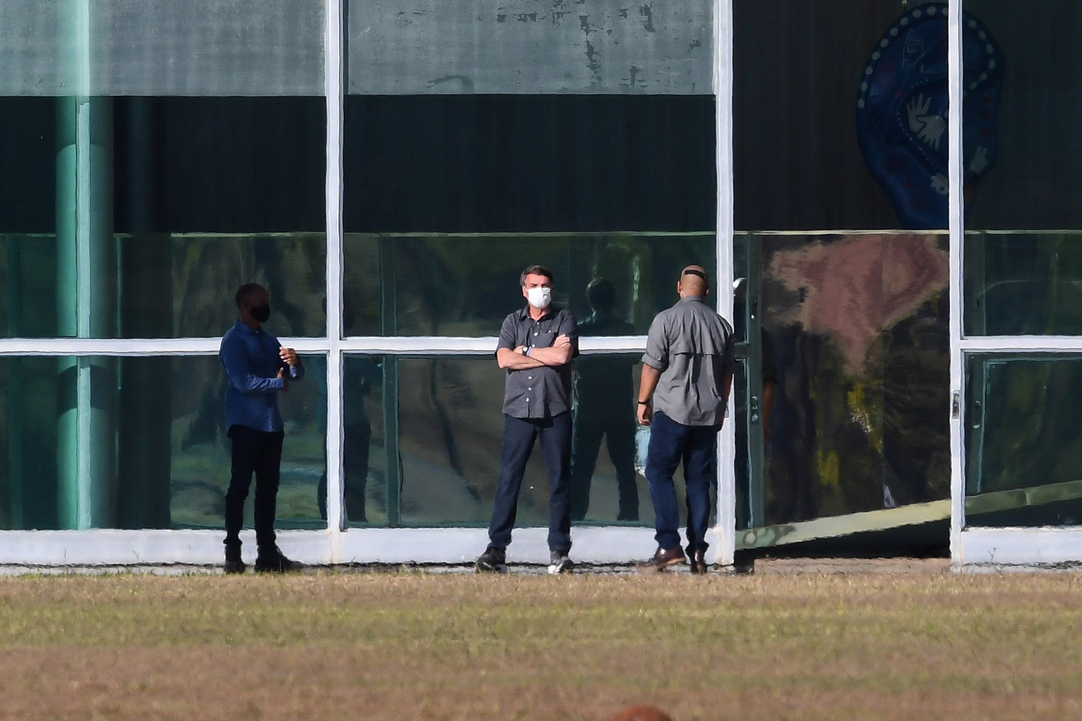 Brazilian President Jair Bolsonaro, center, is seen outside the Alvorada Palace in Brasilia, Brazil, on July 10.