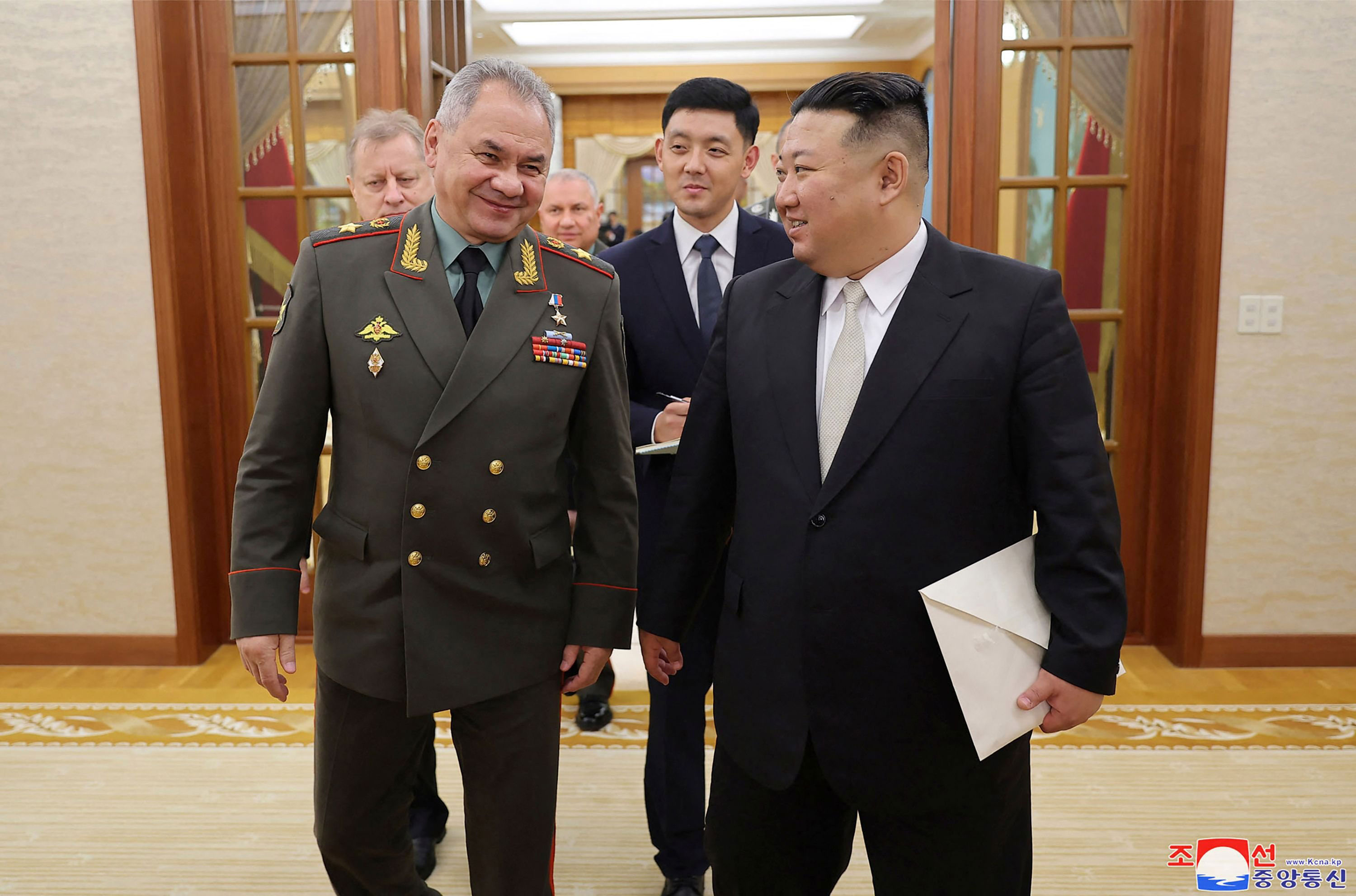 Russian Defence Minister Sergei Shoigu, left, and North Korean leader Kim Jong Un walk together in Pyongyang on Wednesday.