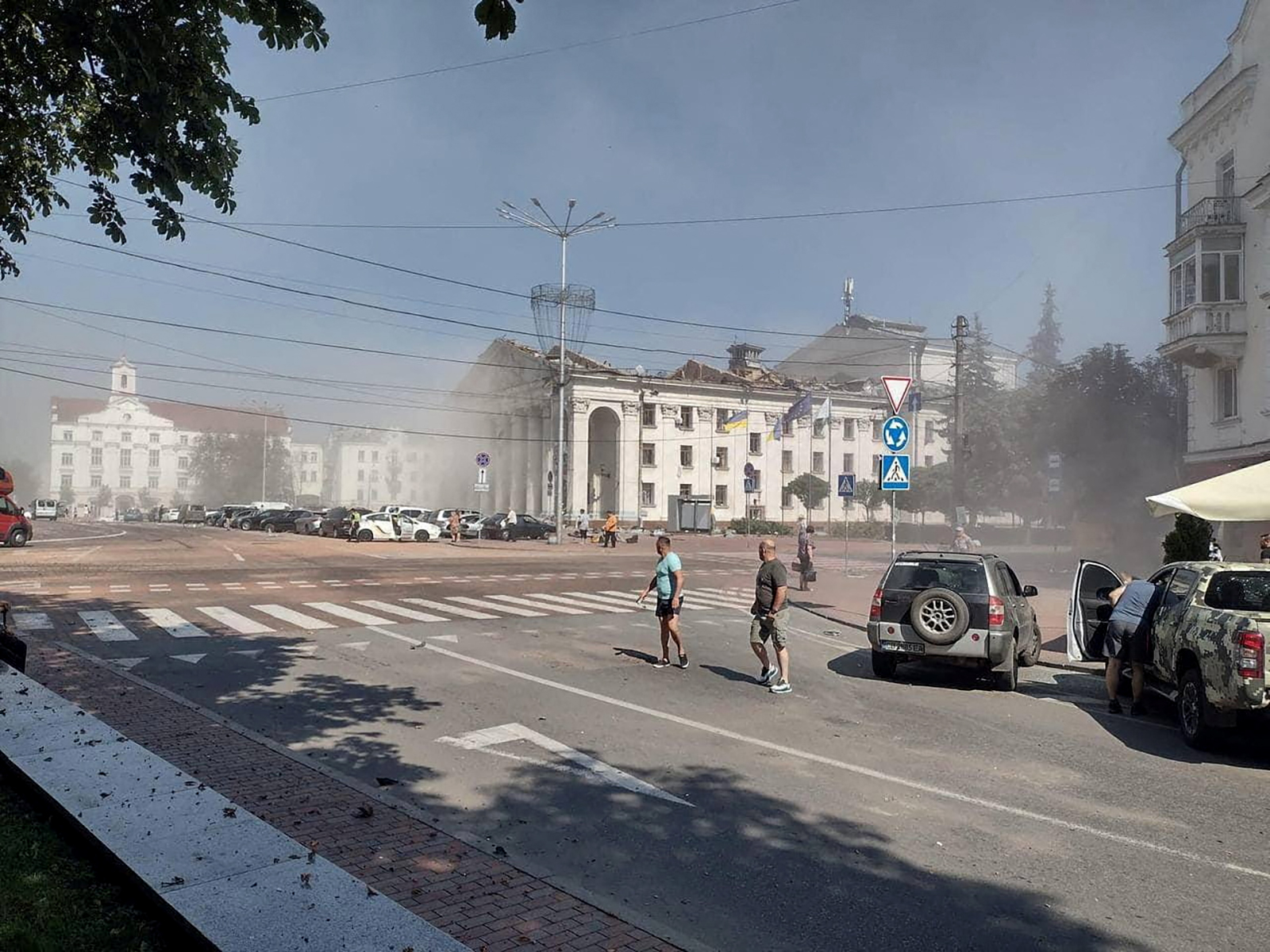 People stand near the site of a Russian missile strike in Chernihiv, Ukraine, on August 19. 