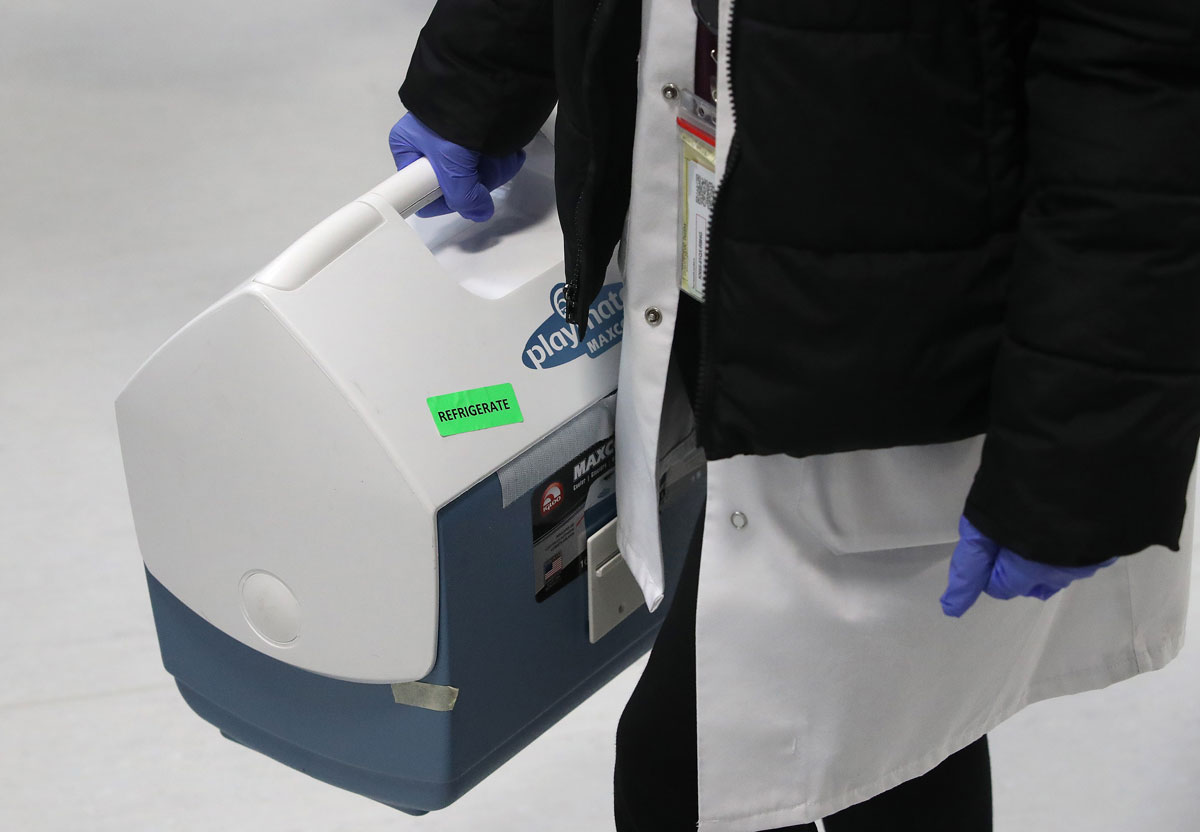 The first doses of Pfizer's Covid-19 vaccine are brought in a cooler to Trillium Health Partners in Ontario, Canada on December 21, 2020.