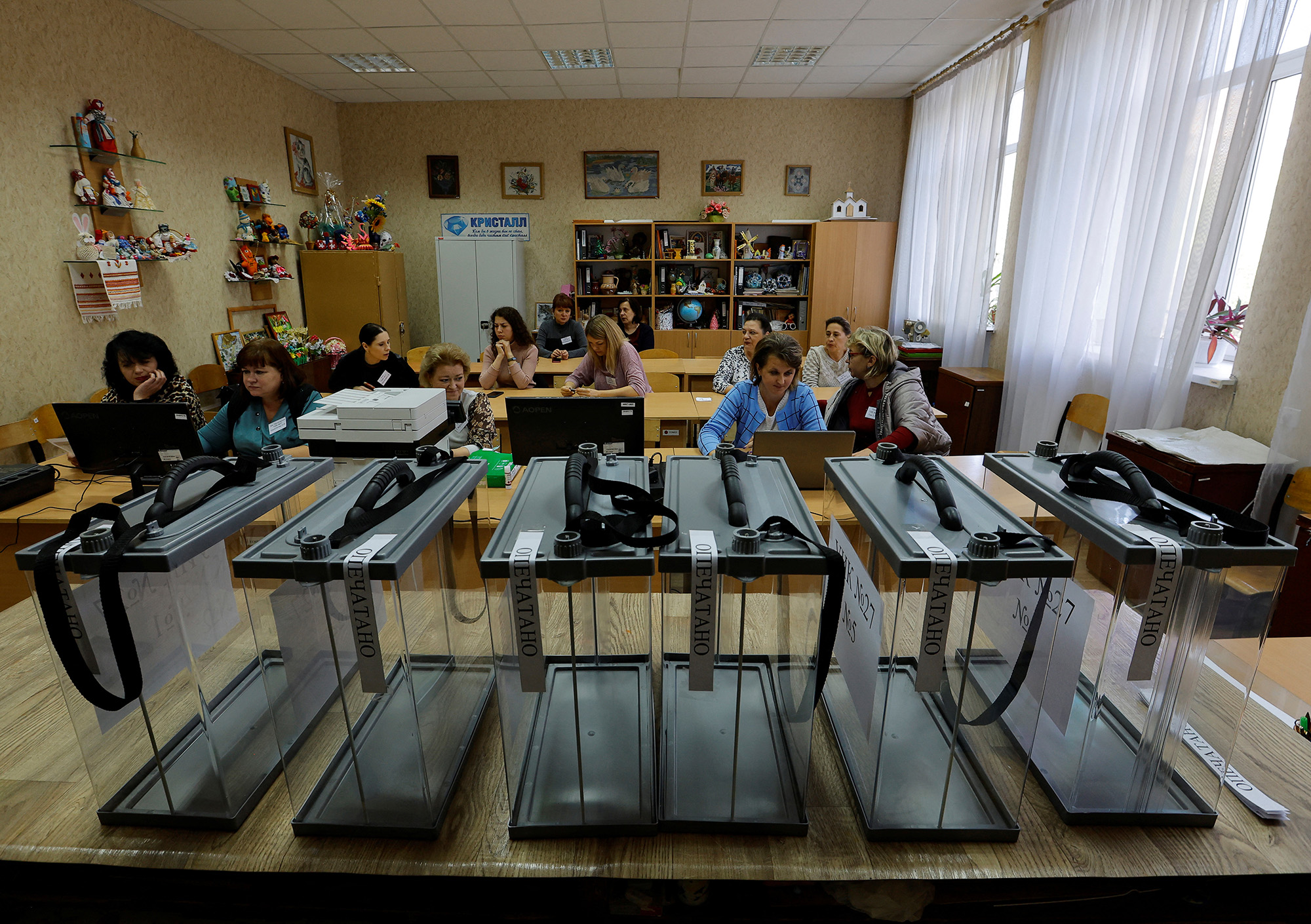 Members of the local electoral commission gather at a polling station ahead of the planned referendum on the joining of the self-proclaimed Donetsk people's republic to Russia, in Donetsk, Ukraine, on September 22.
