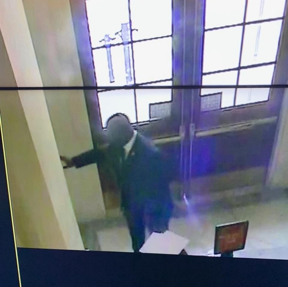 In this photo obtained by CNN, Rep. Jamaal Bowman reportedly pulls a fire alarm in the Cannon House Office Building on Saturday morning, shortly before the House was scheduled to vote on a government funding bill, which the New York Democrat claims was an accident.