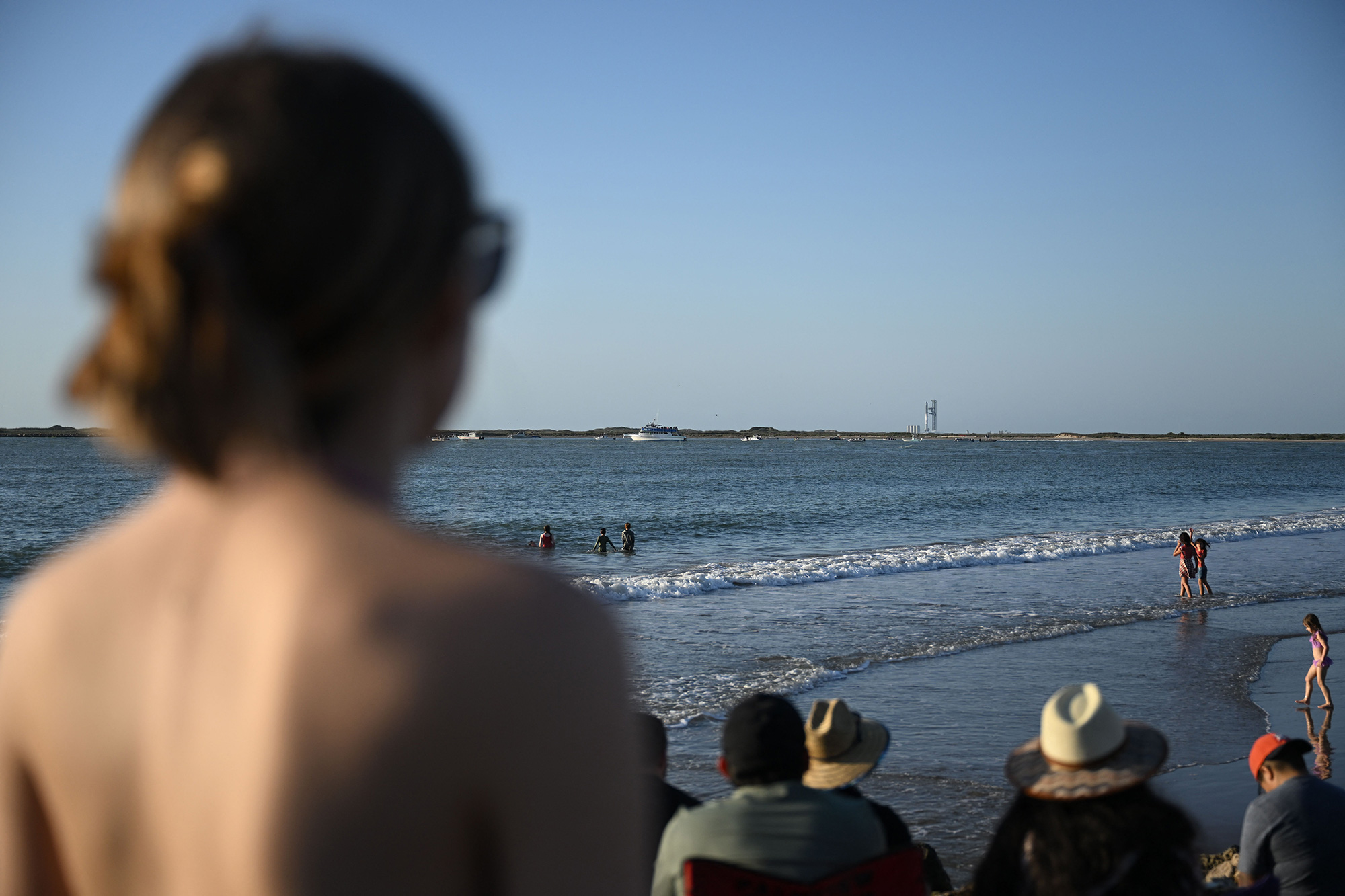 Observers on the beach gather to watch the launch of the SpaceX Starship rocket near Brownsville, Texas, on Monday April 17.