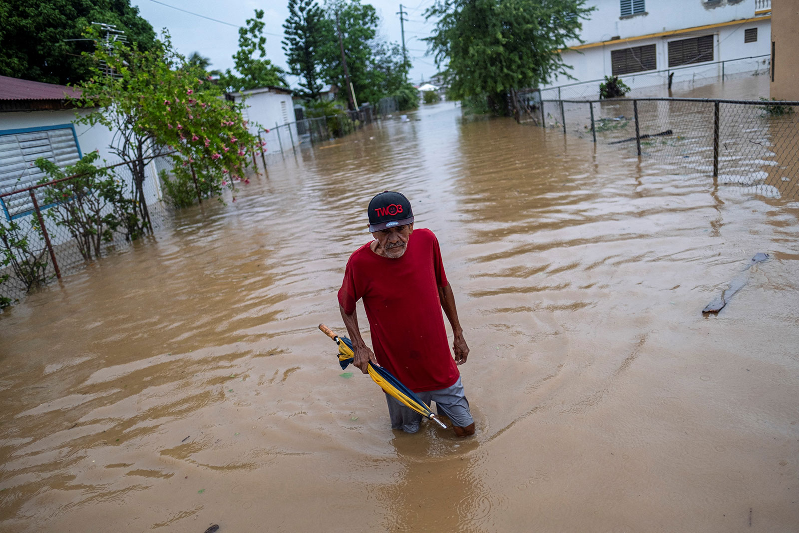 A man wades through water in a flooded street in the aftermath of Hurricane Fiona in Salinas, Puerto Rico on September 19. 