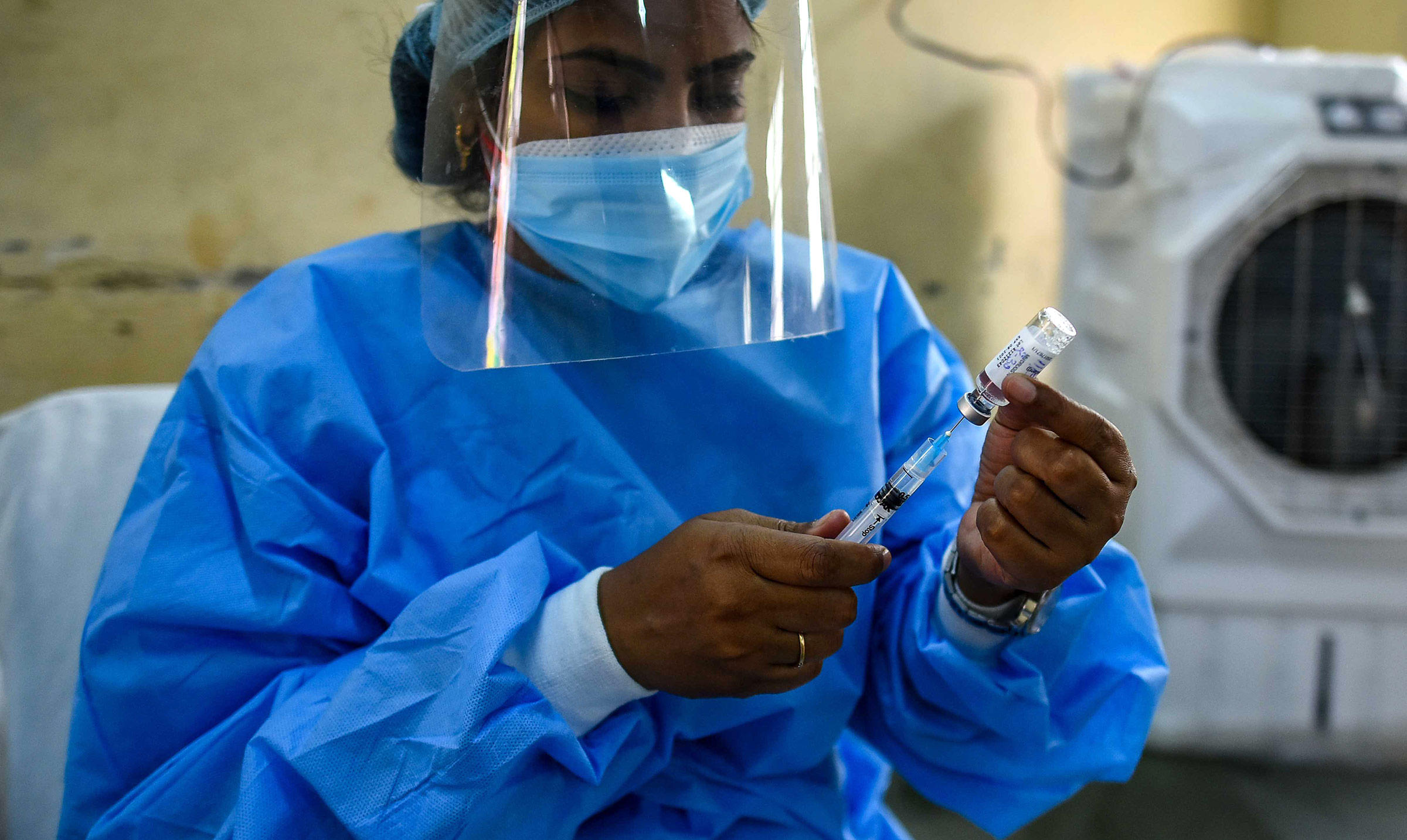 A health worker prepares a dose of the AstraZeneca Covid-19 vaccine on May 11, in New Delhi, India. 