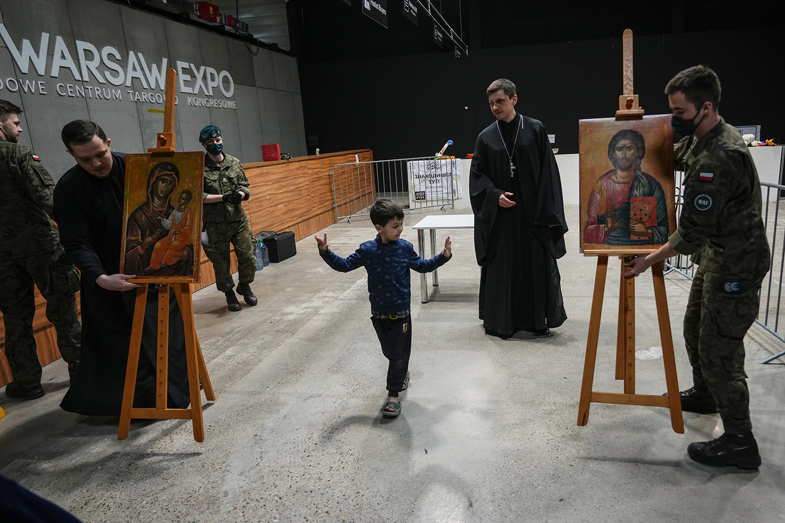 Priests and Poland servicemen prepare for an Orthodox prayer at a refugee center in Nadarzyn, near Warsaw, Poland, on March 25. 